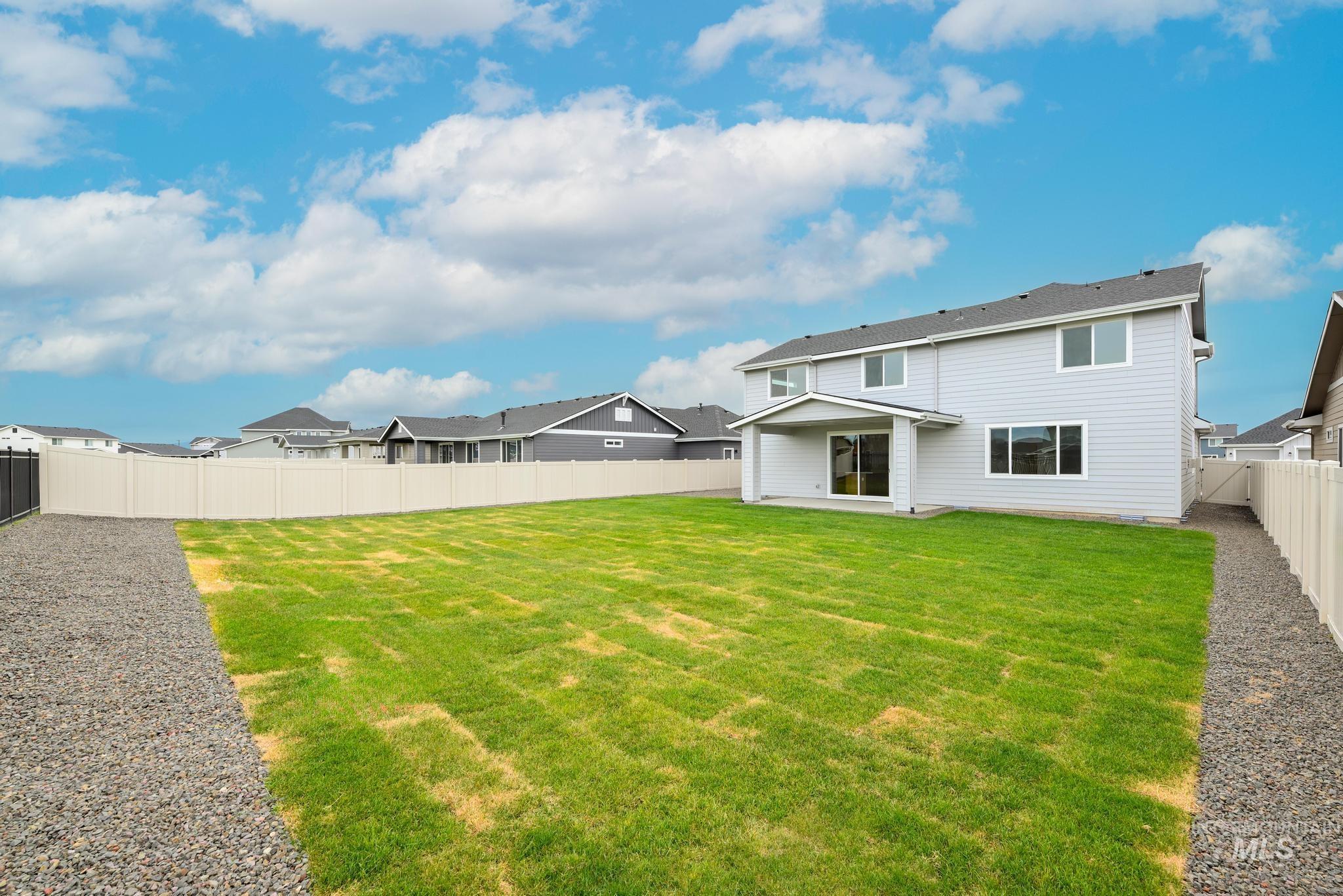 Rear view of property with a patio, a fenced backyard, and a residential view