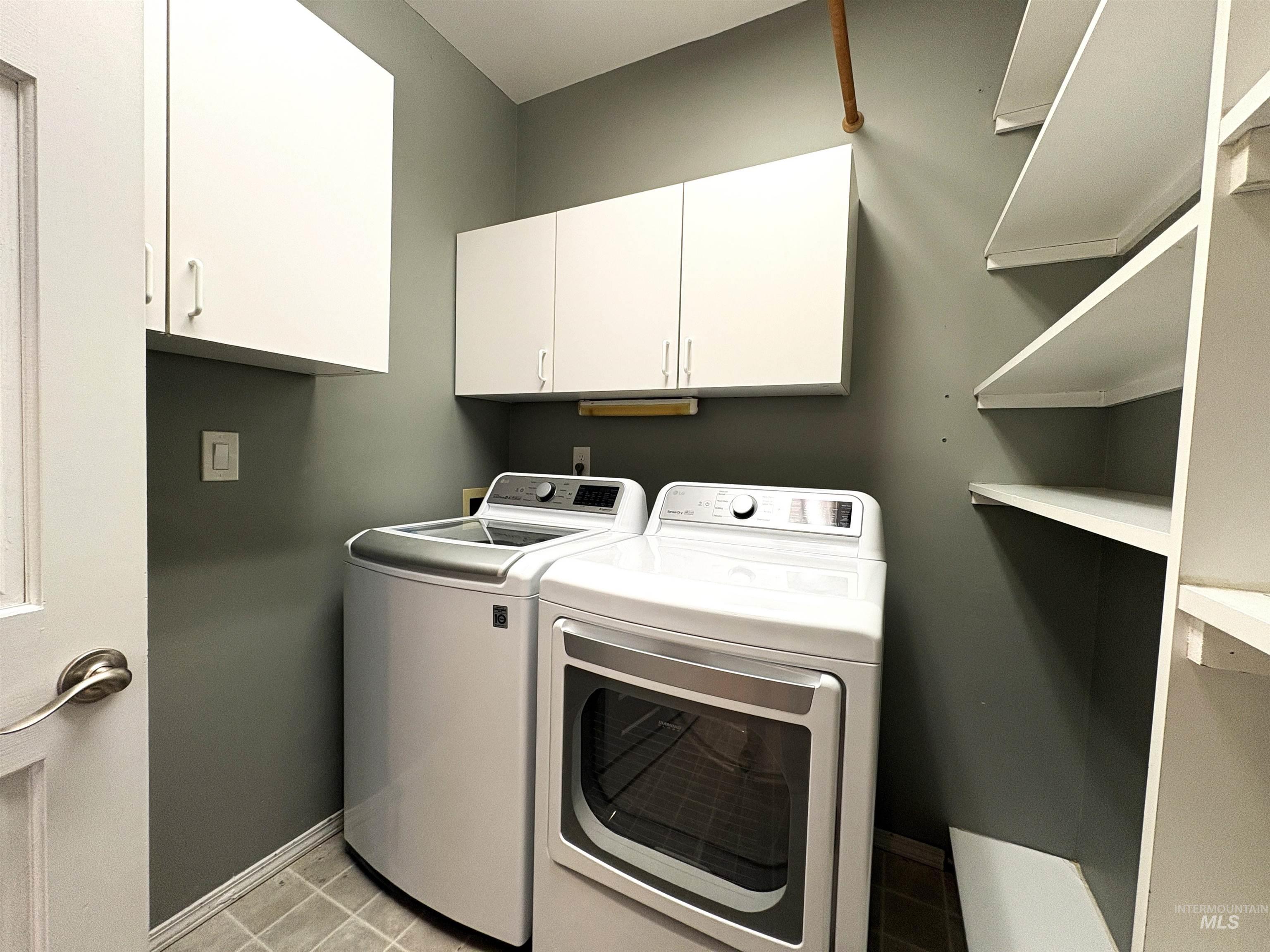 Laundry room featuring washer and dryer and pantry space.