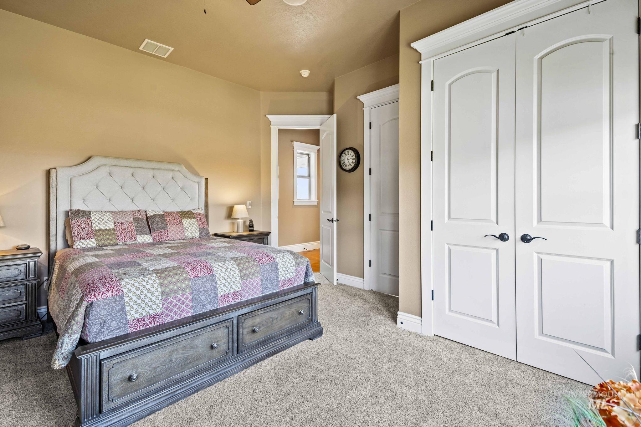 Bedroom with a closet and light carpet