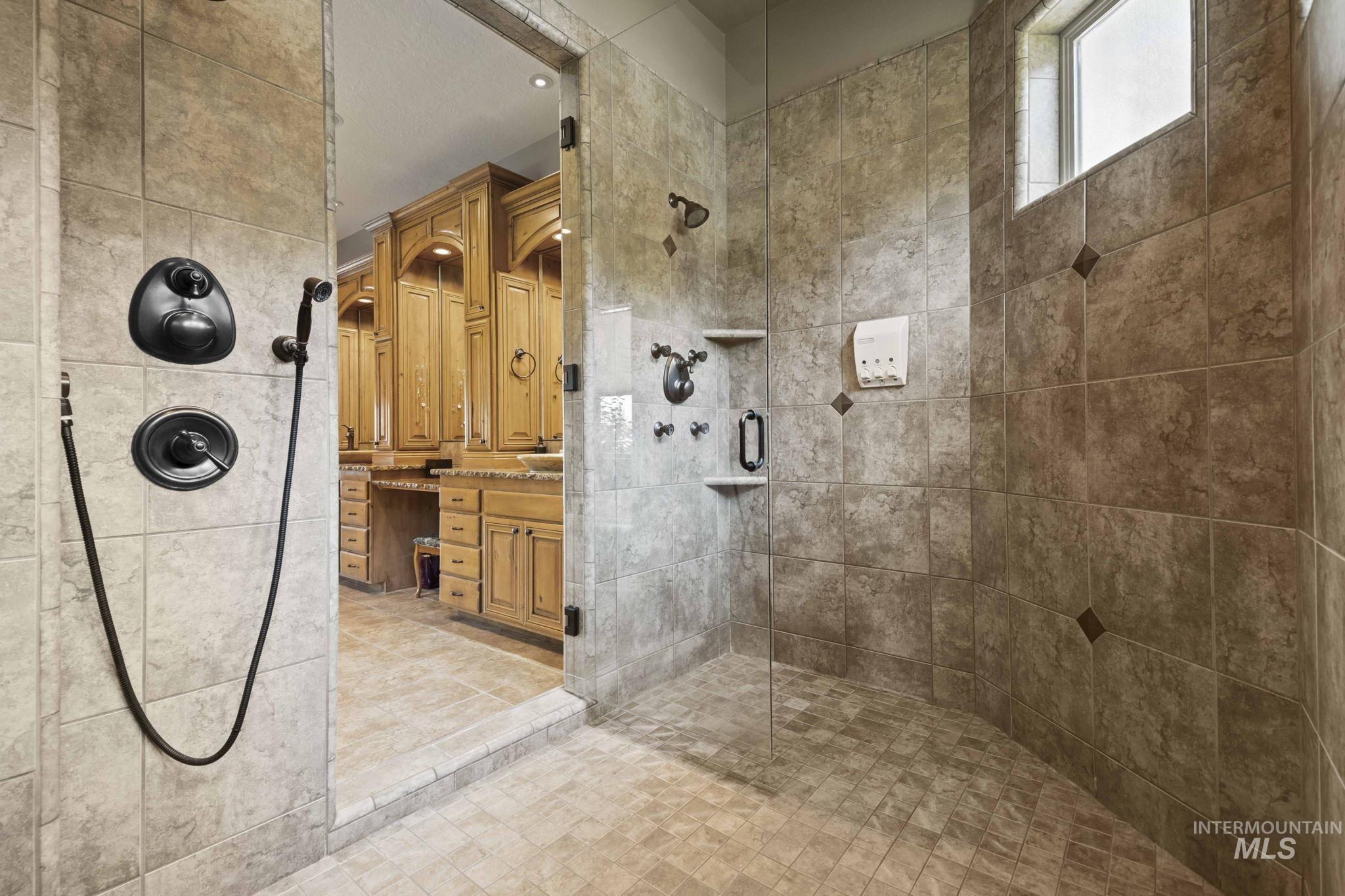 Bathroom featuring a stall shower and vanity