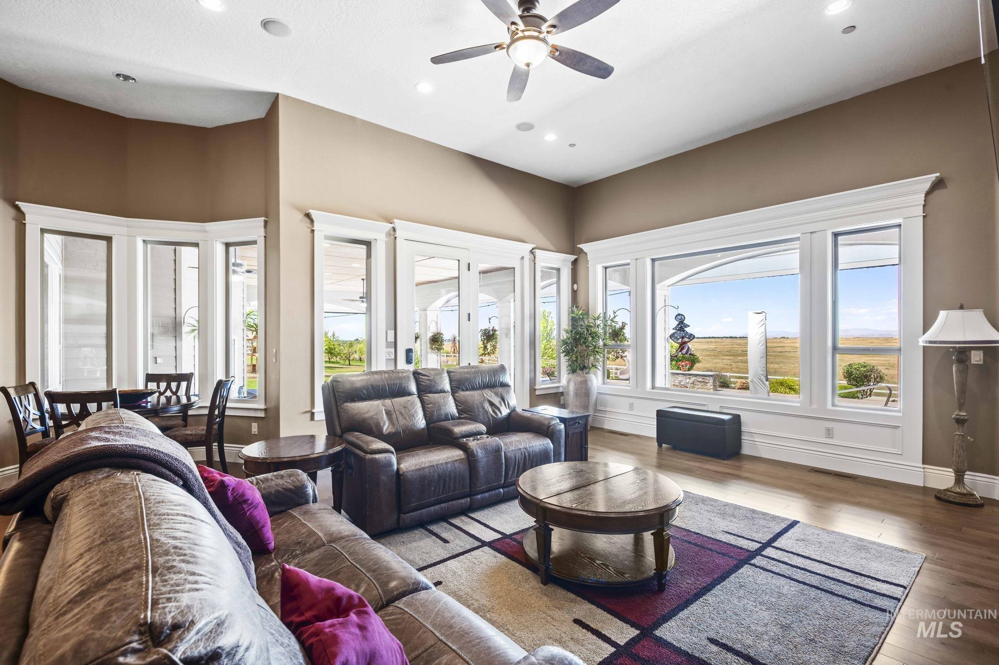 Living area featuring recessed lighting, ceiling fan, and wood finished floors