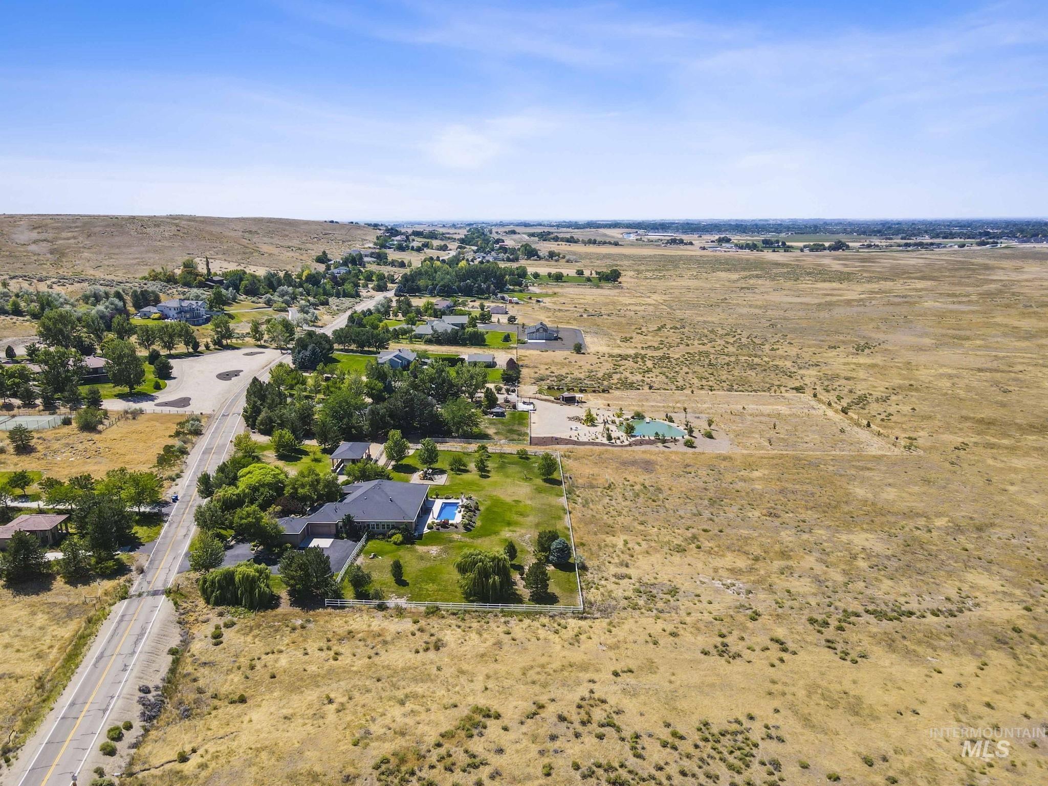 Aerial view of property and surrounding area with rural landscape