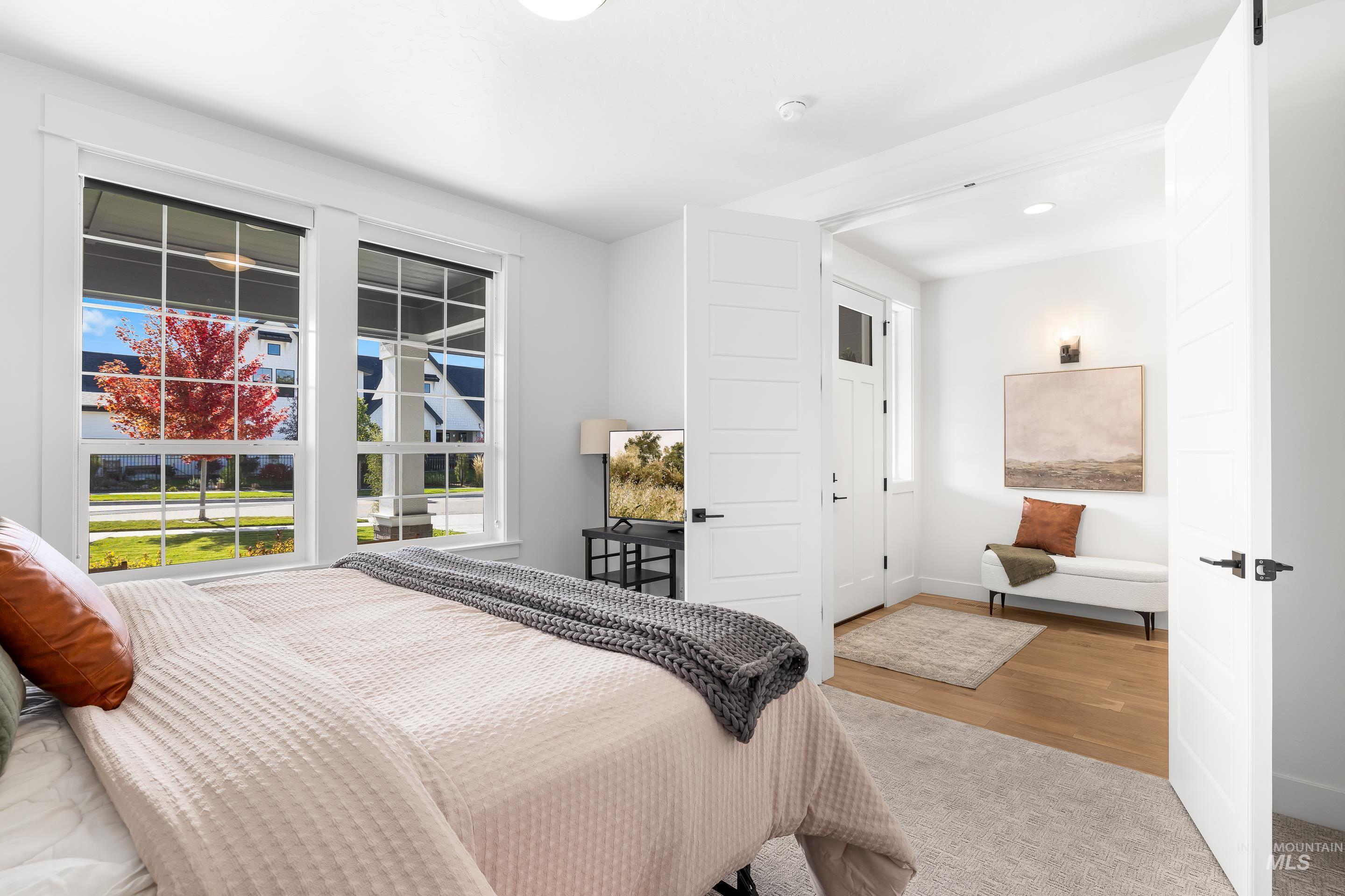 Bedroom with baseboards and wood finished floors