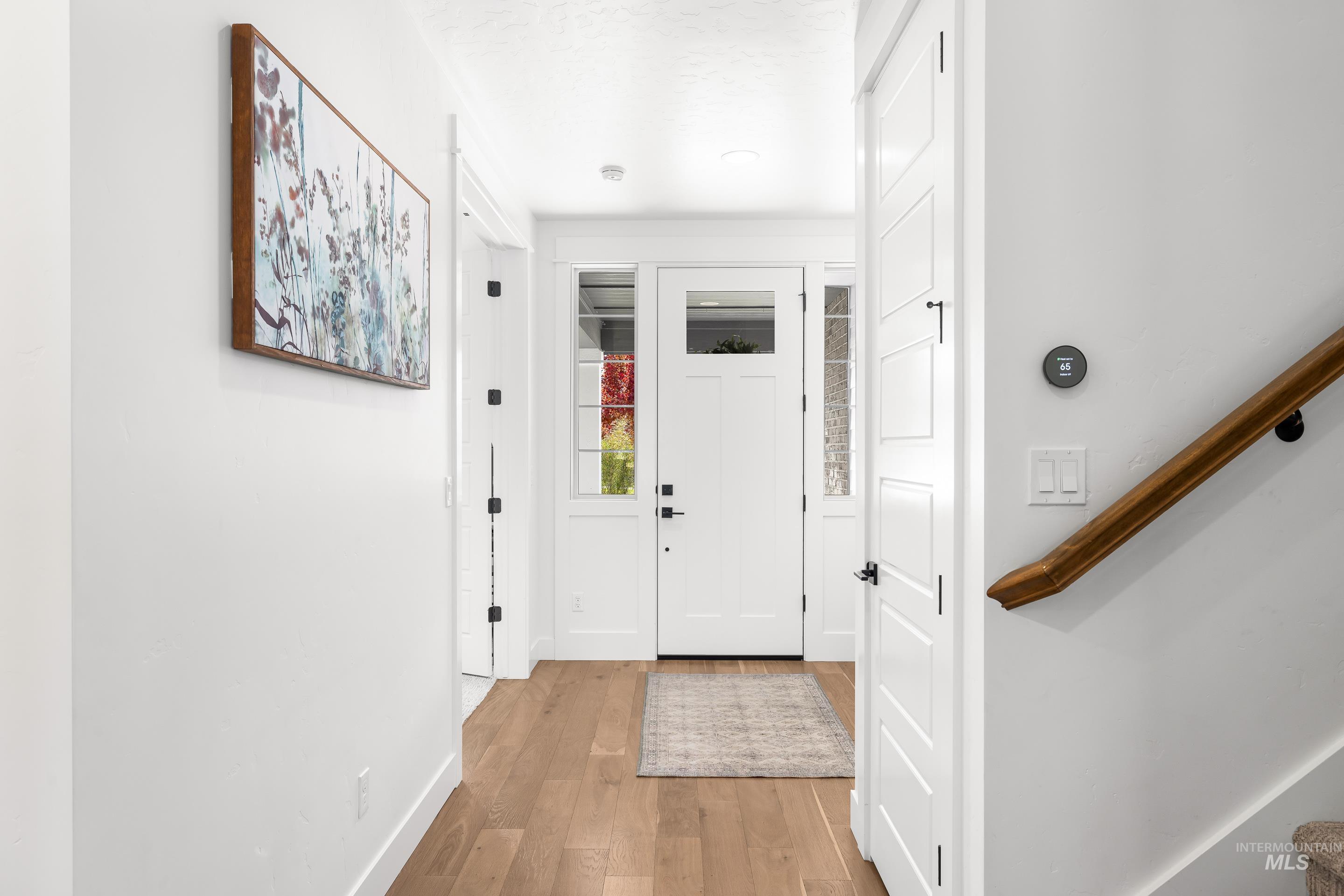 Foyer entrance with baseboards and wood finished floors