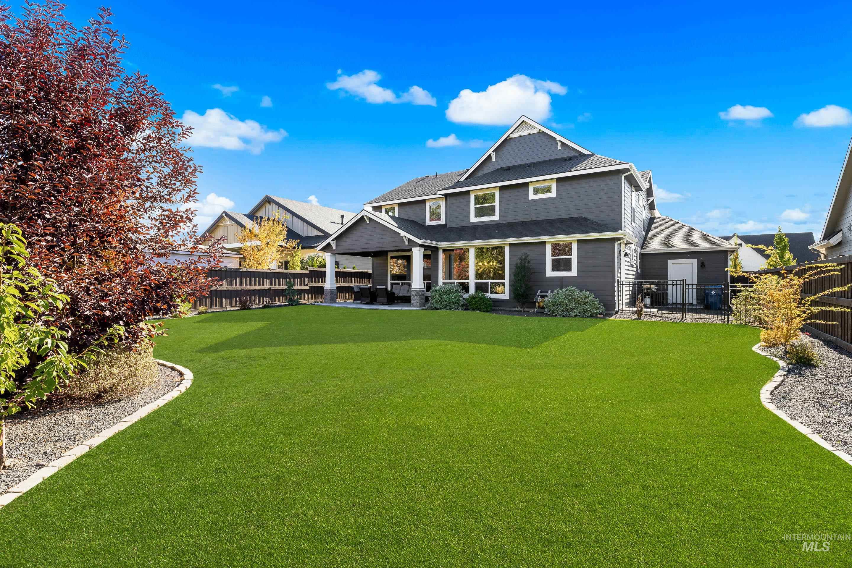 Back of property featuring a patio, a fenced backyard, and roof with shingles