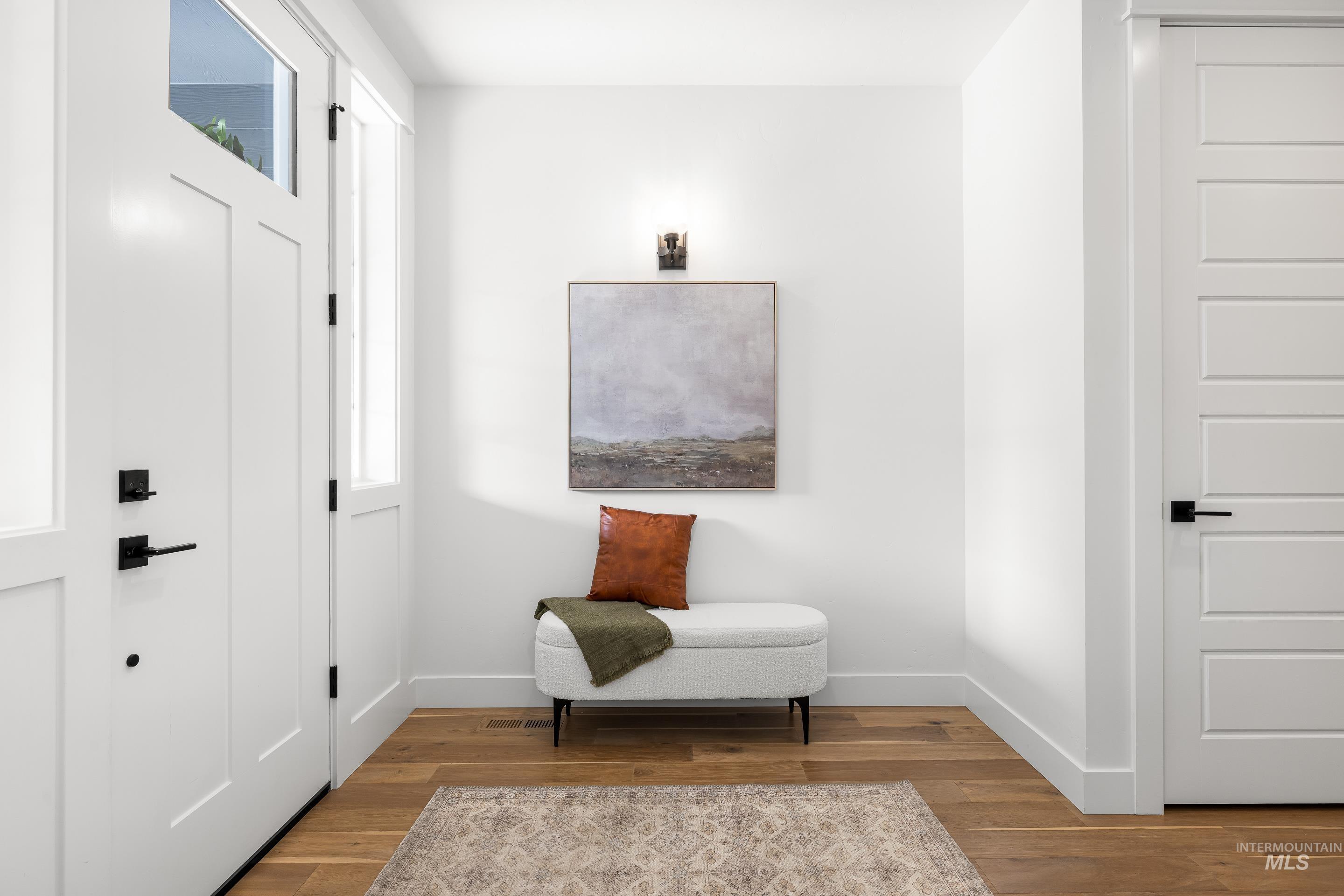Living area with baseboards and wood finished floors