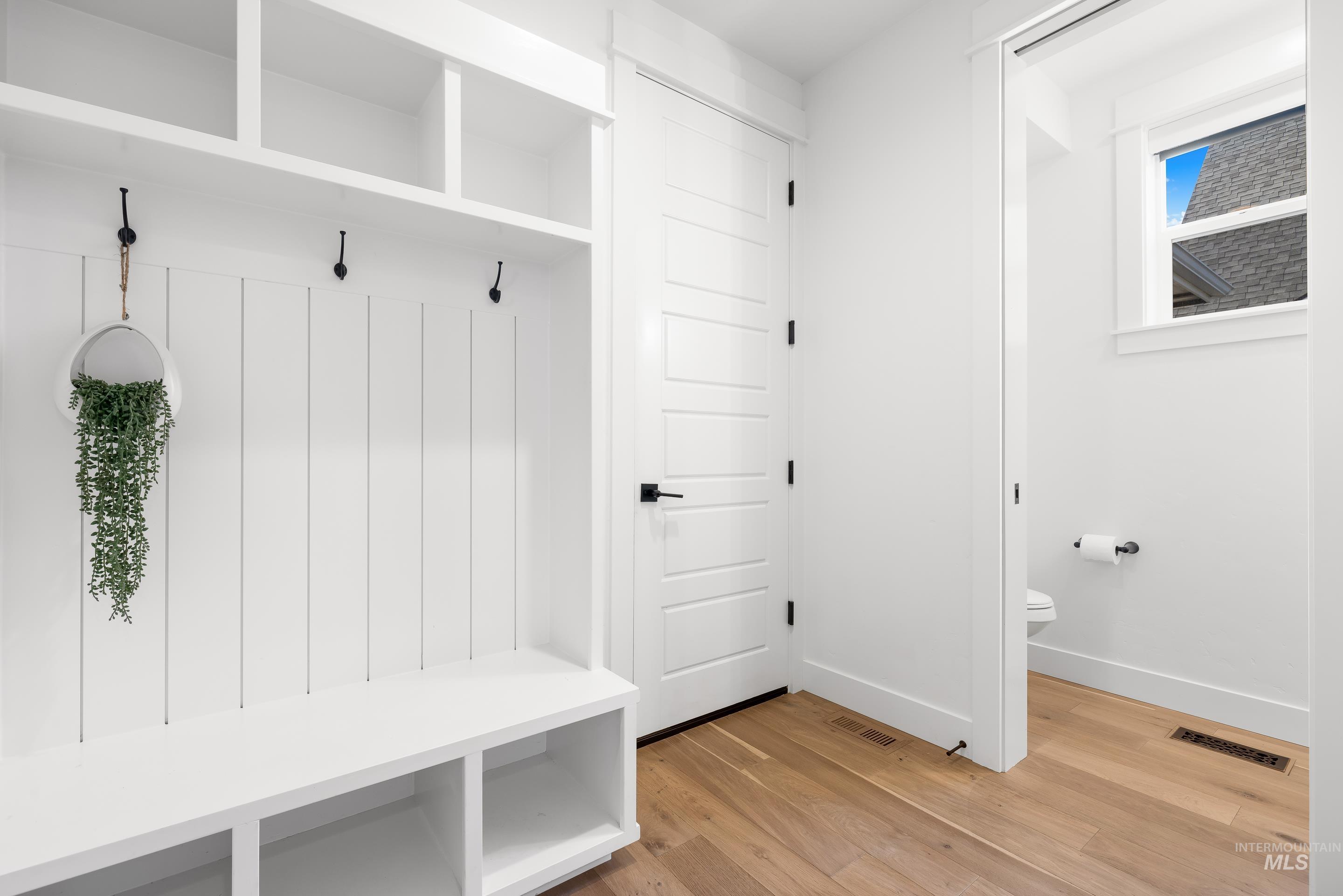 Mudroom featuring light wood-type flooring and baseboards