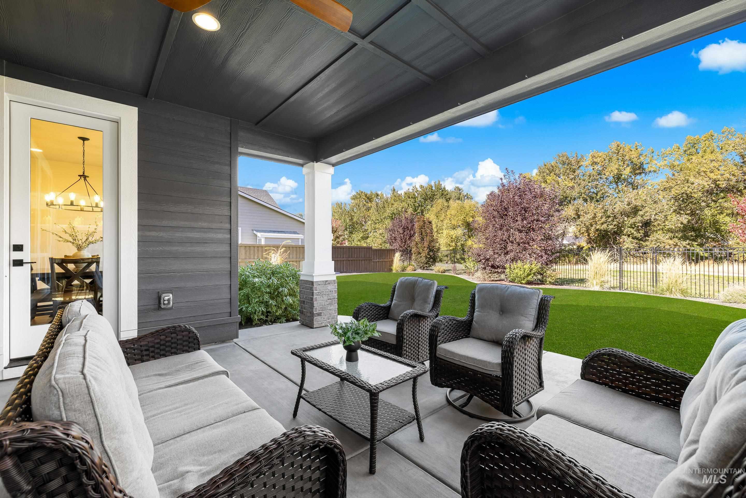 Fenced backyard with an outdoor living space and a patio area