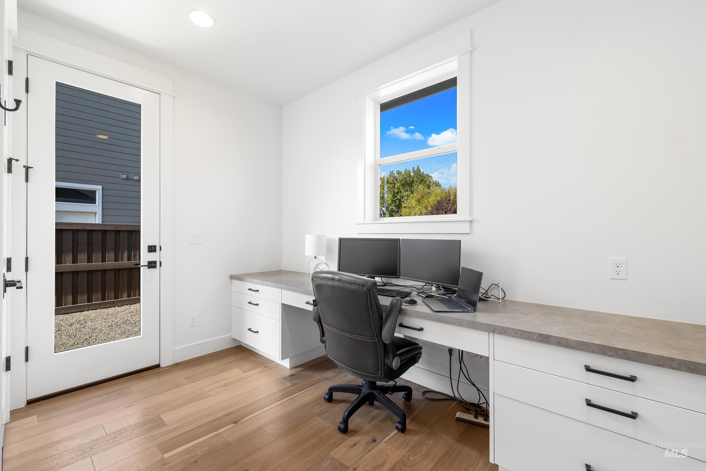 Home office featuring light wood-type flooring, recessed lighting, and built in study area