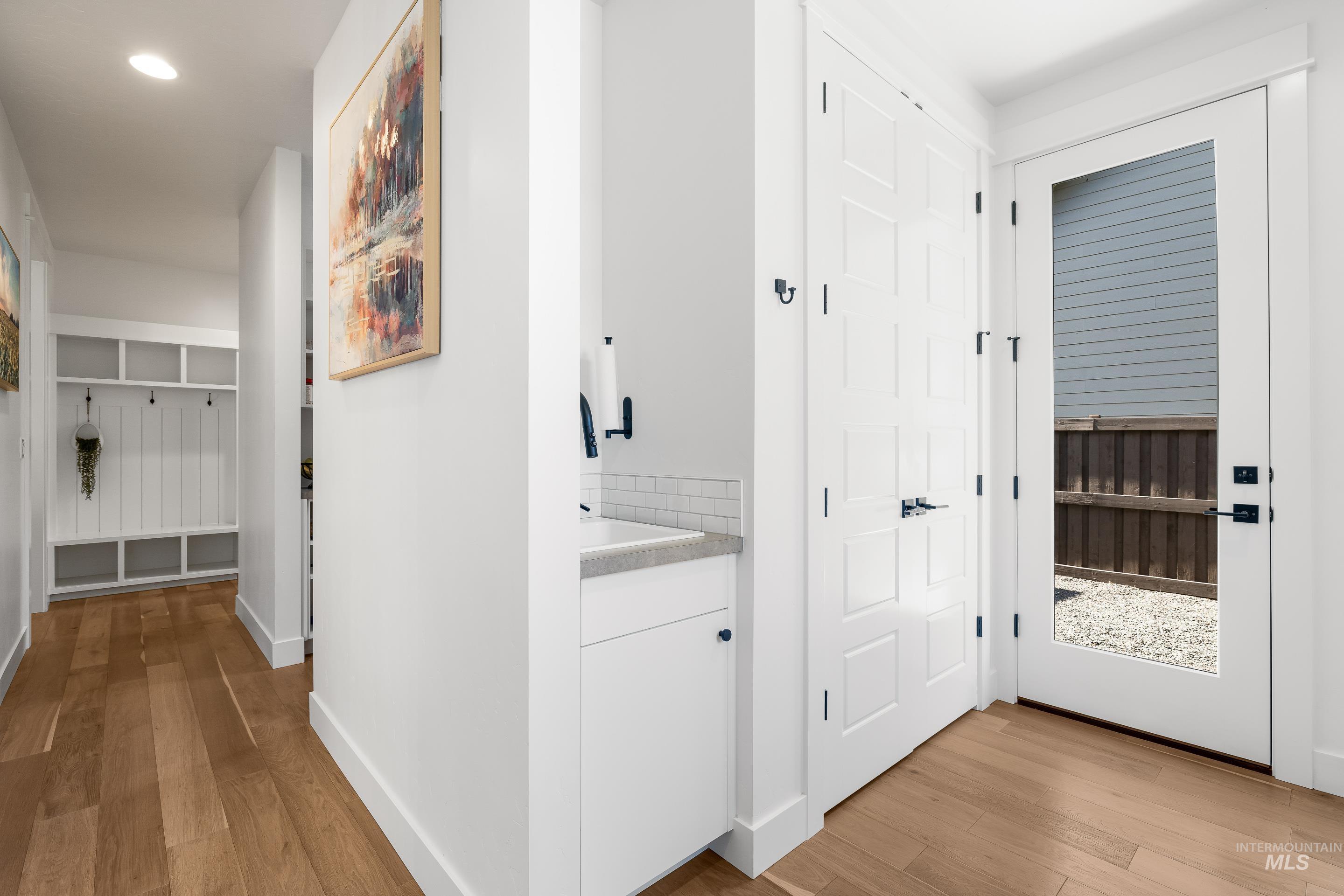 Corridor featuring light wood finished floors and recessed lighting