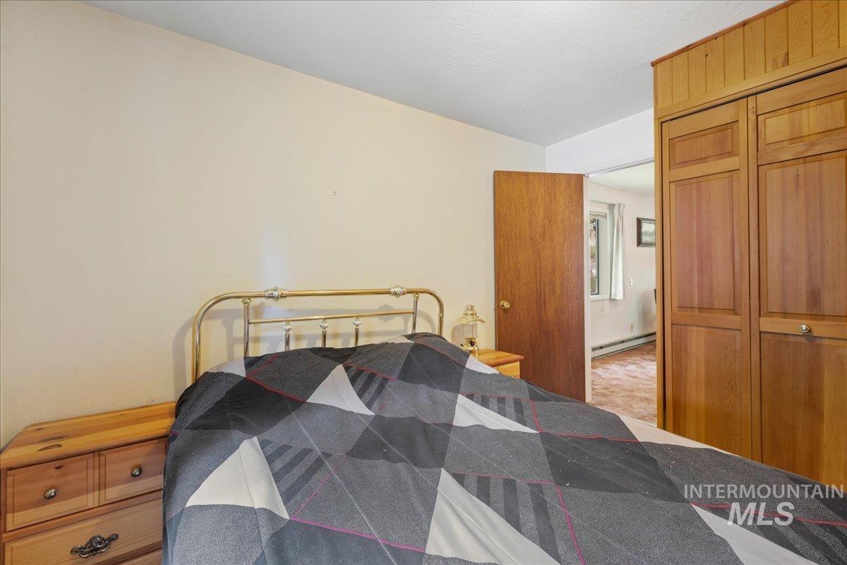 Bedroom featuring a closet and baseboard heating