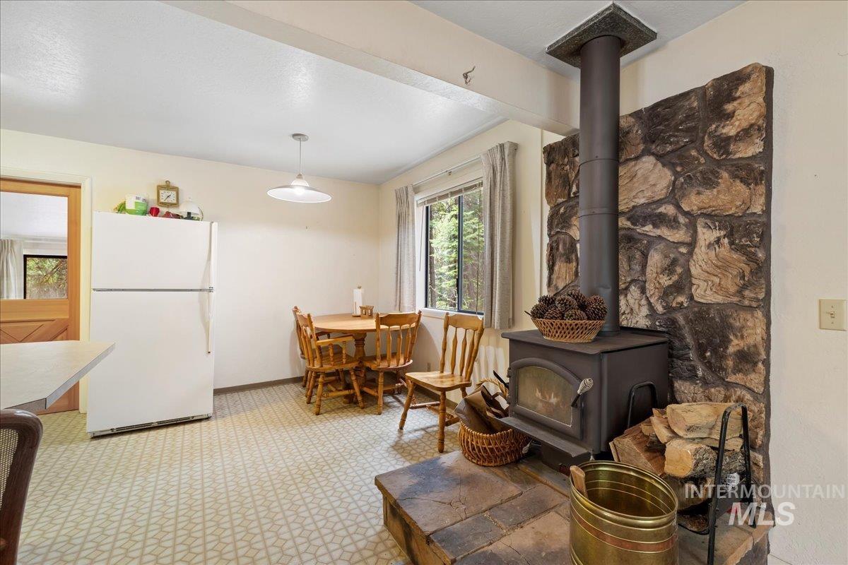 Dining area with a wood stove and baseboards