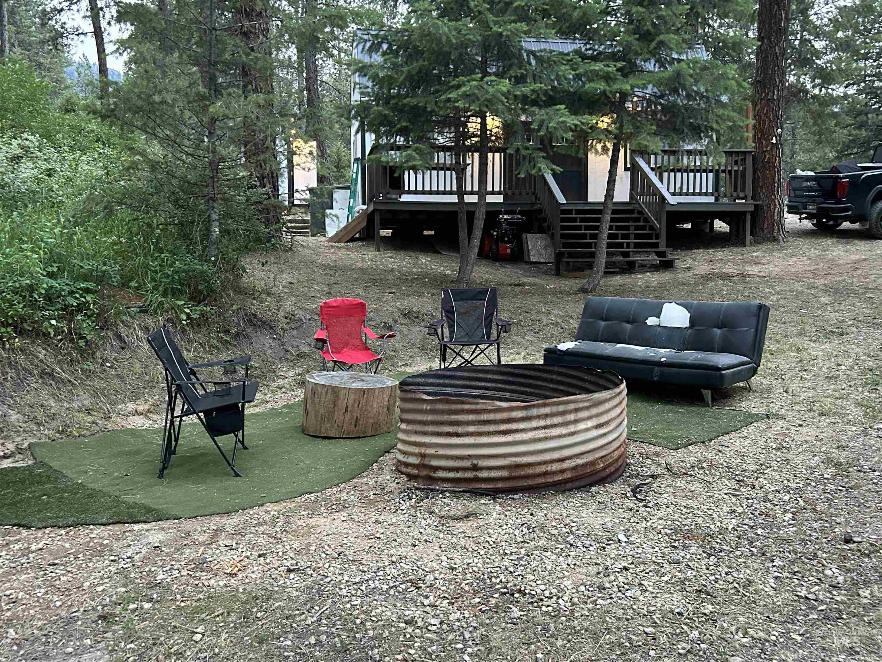 View of yard featuring stairway, an outdoor fire pit, and a deck