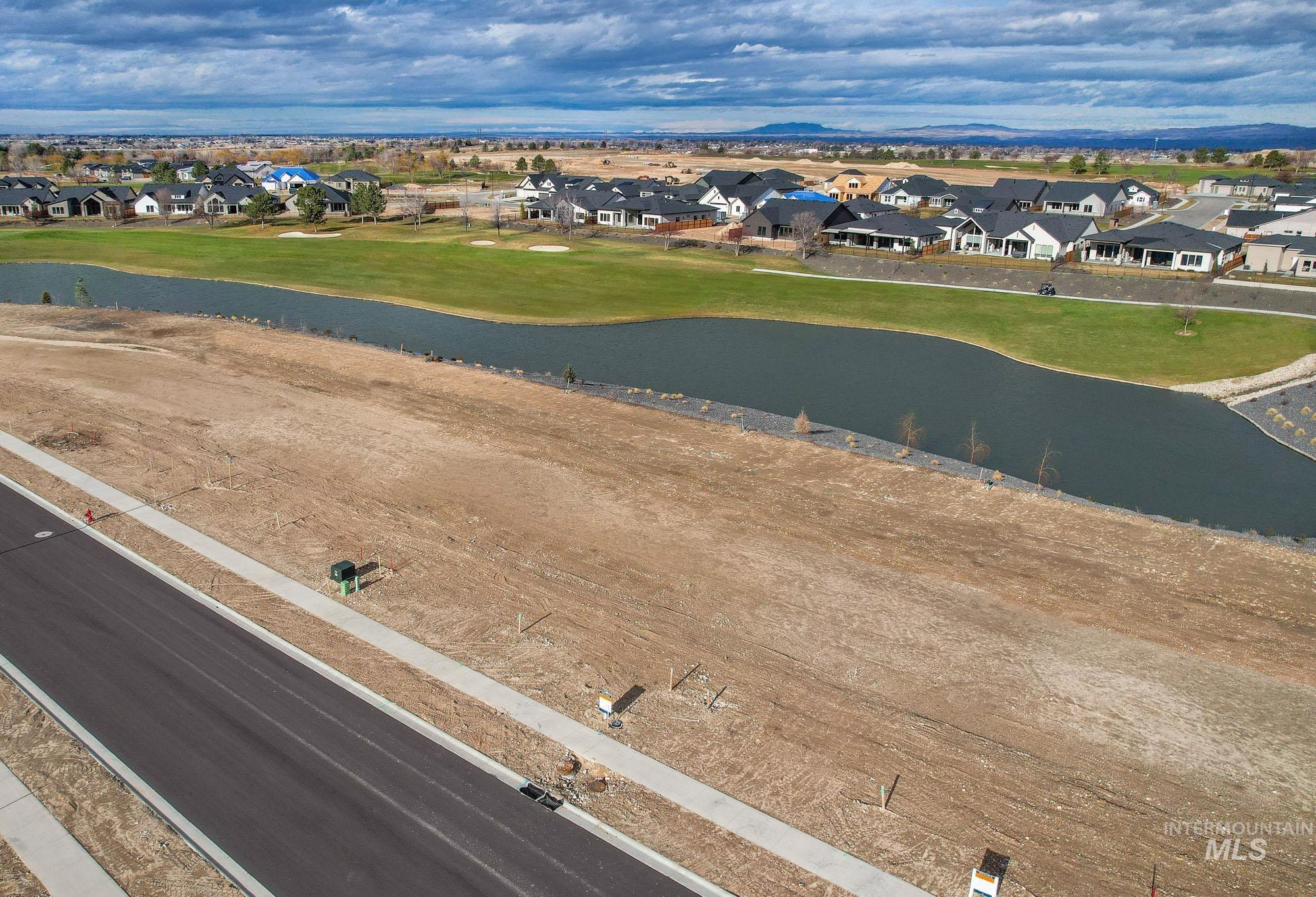 Aerial view of residential area featuring a nearby body of water