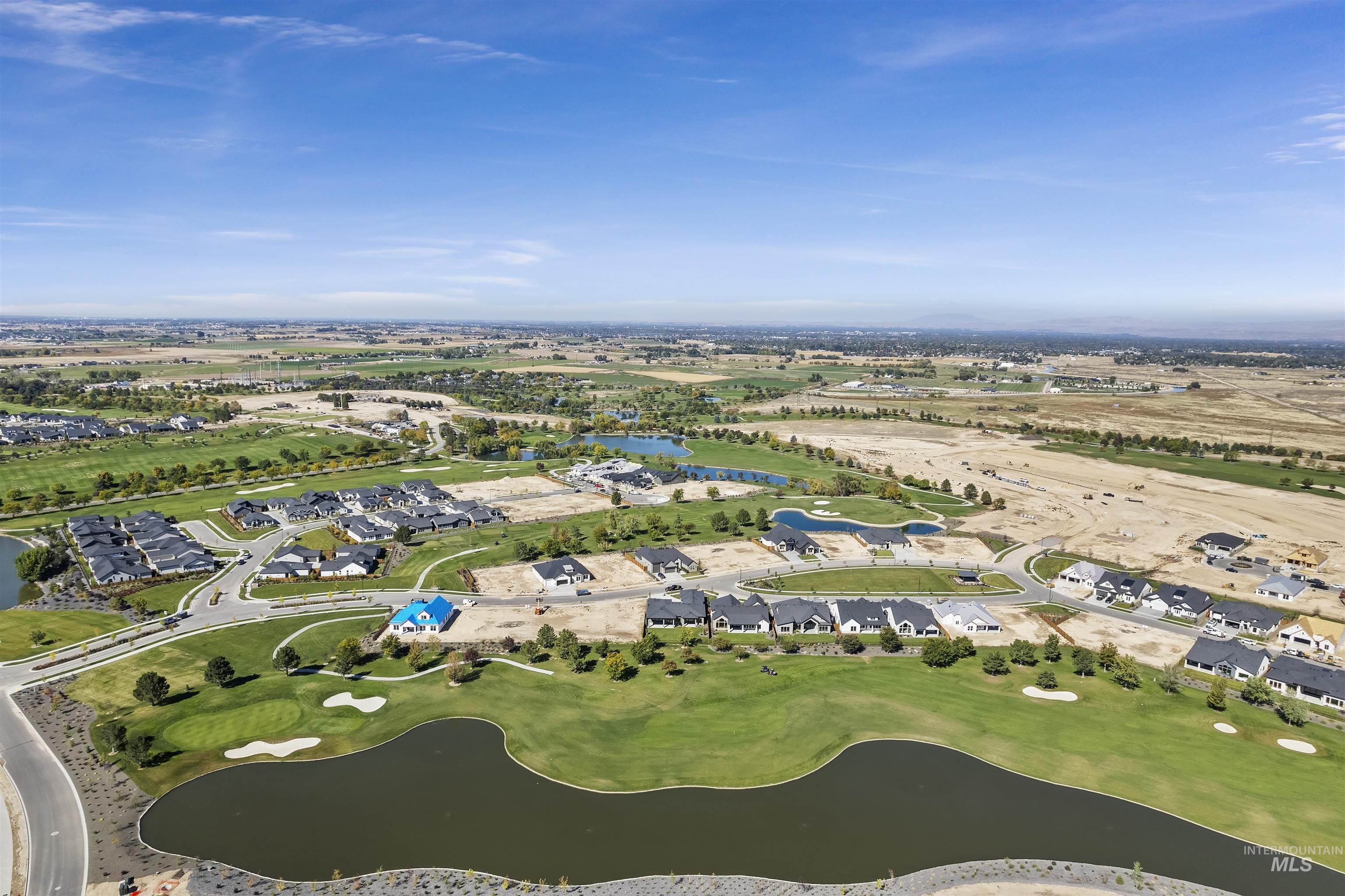 Aerial view of residential area with a large body of water and a golf course