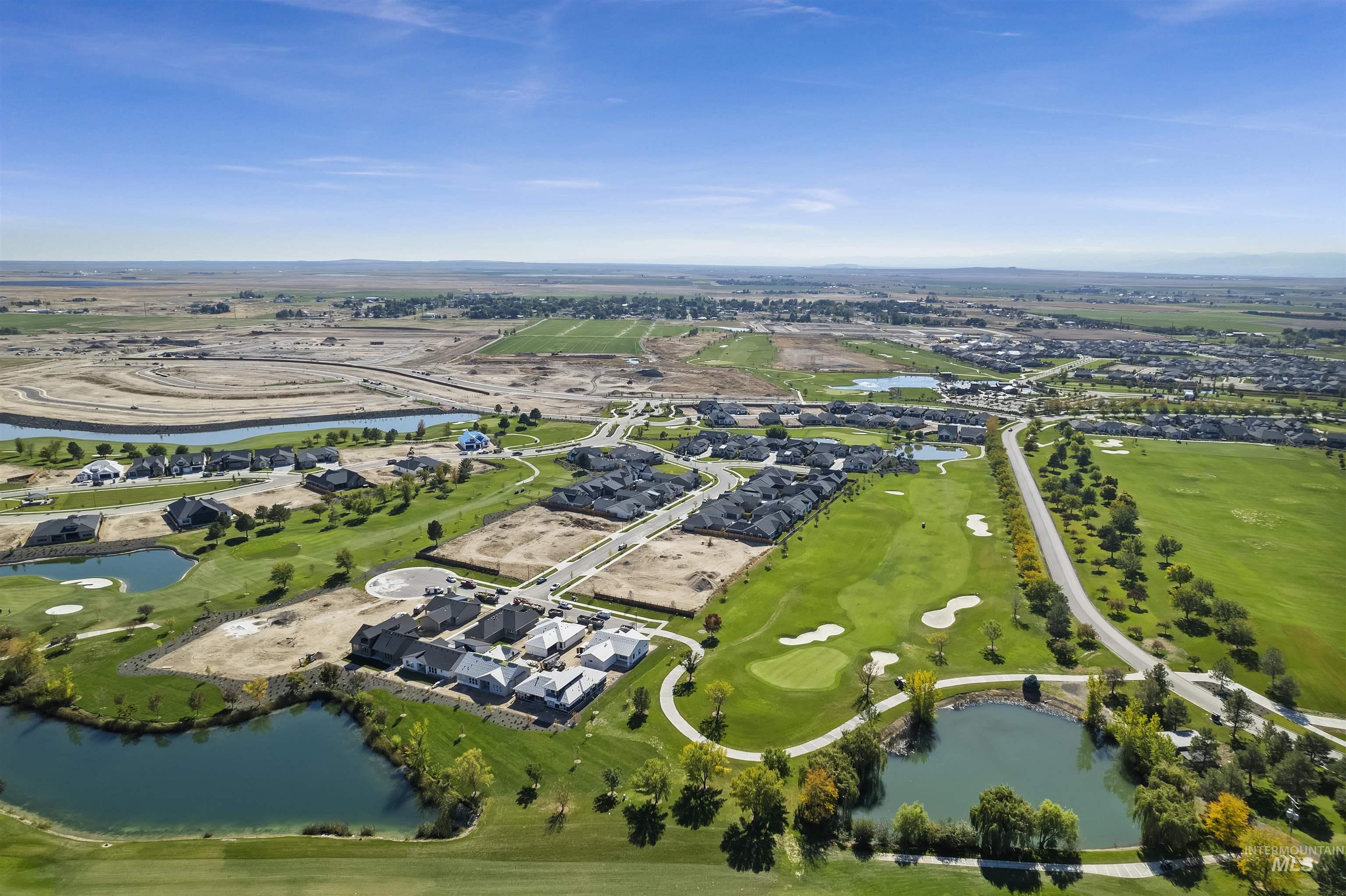 Aerial overview of property's location featuring a large body of water, a local golf course, and nearby suburban area