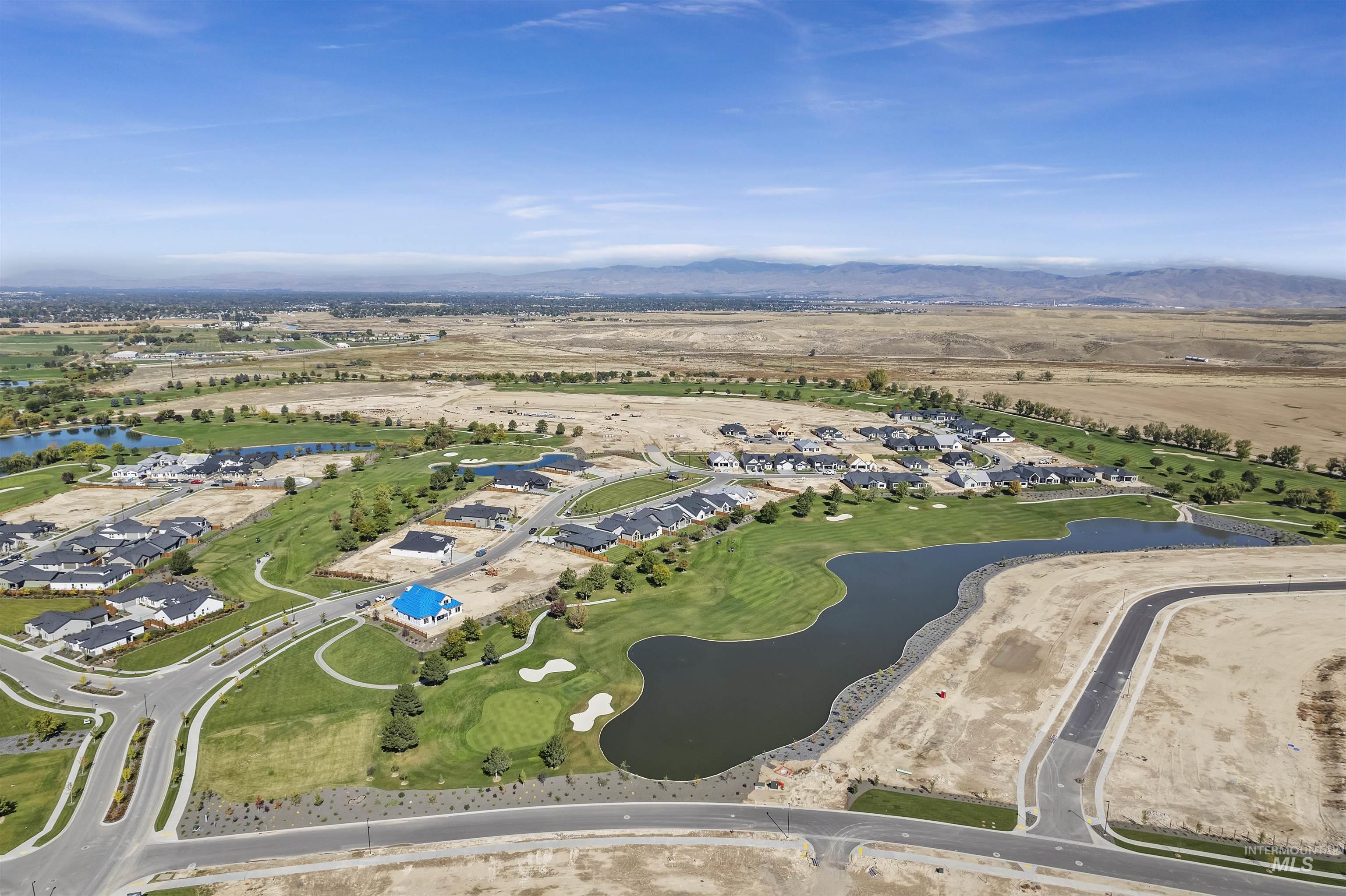 Aerial view of residential area featuring a water and mountain view