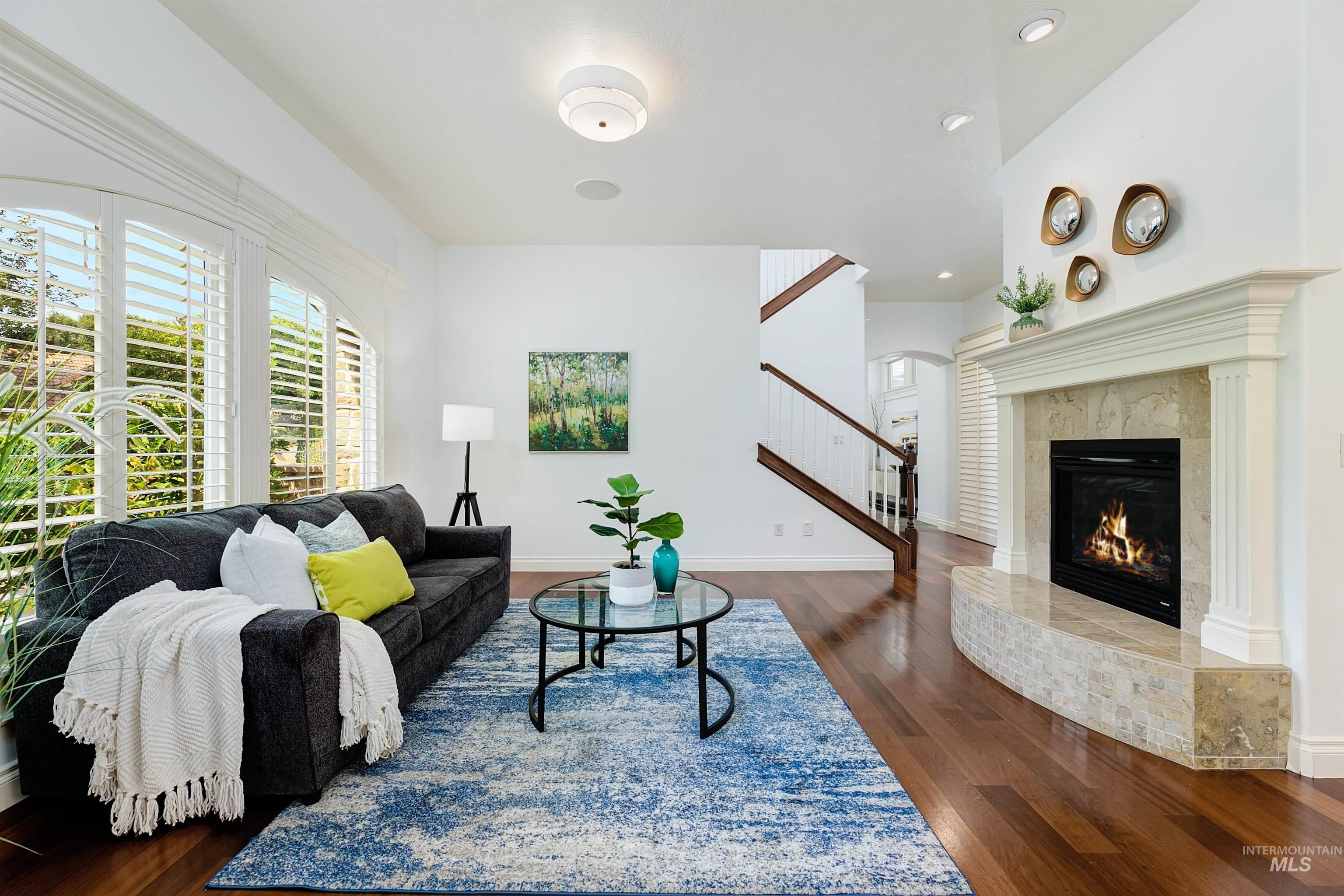 Living area featuring dark wood finished floors and a premium fireplace