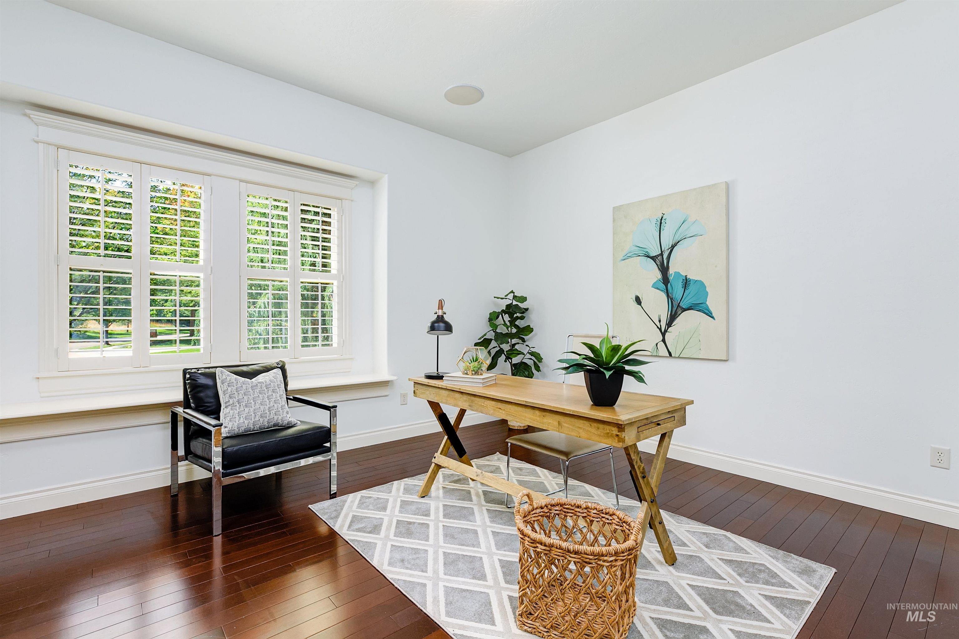 Office area featuring dark wood finished floors and baseboards