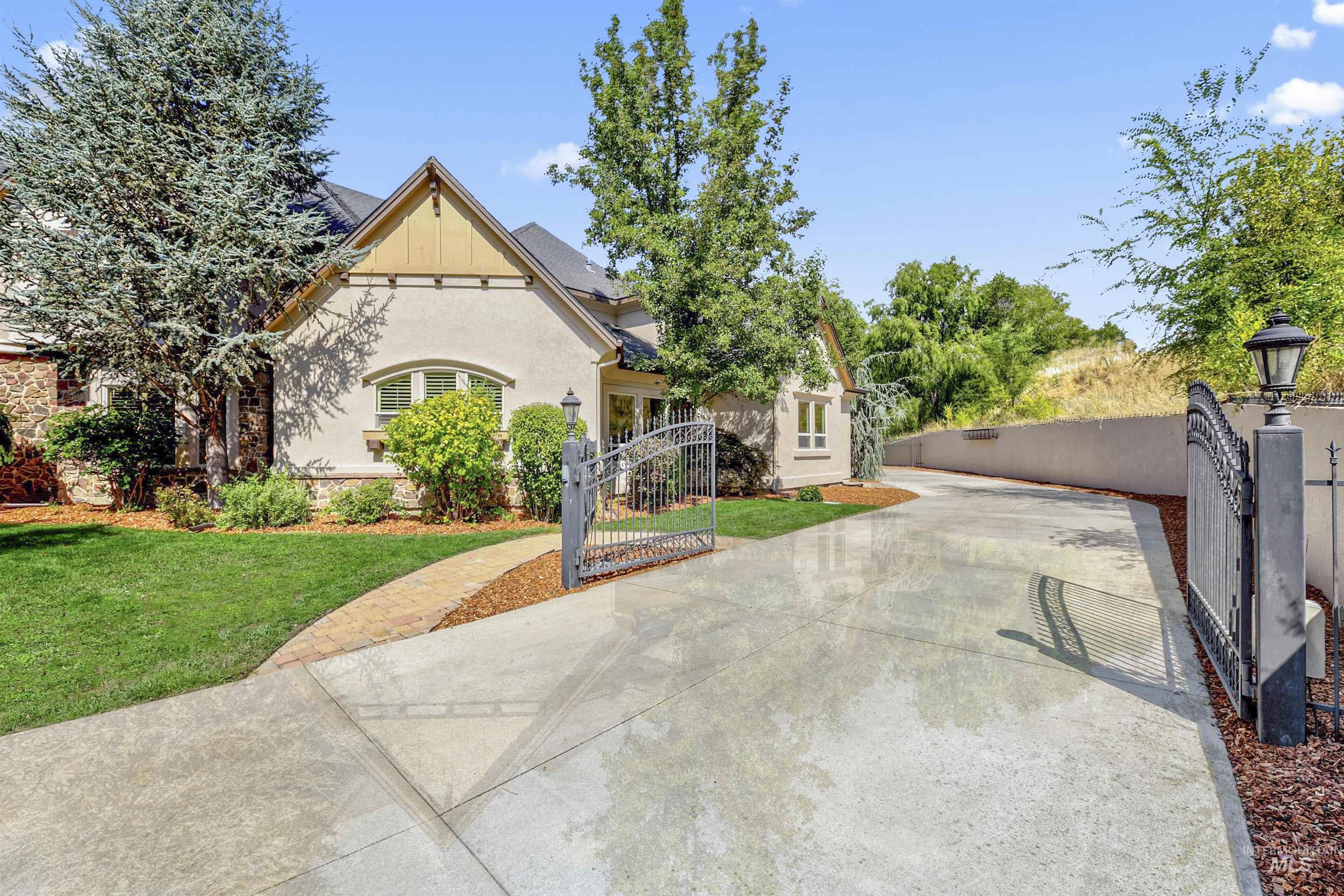 View of front of property featuring a gate and stucco siding