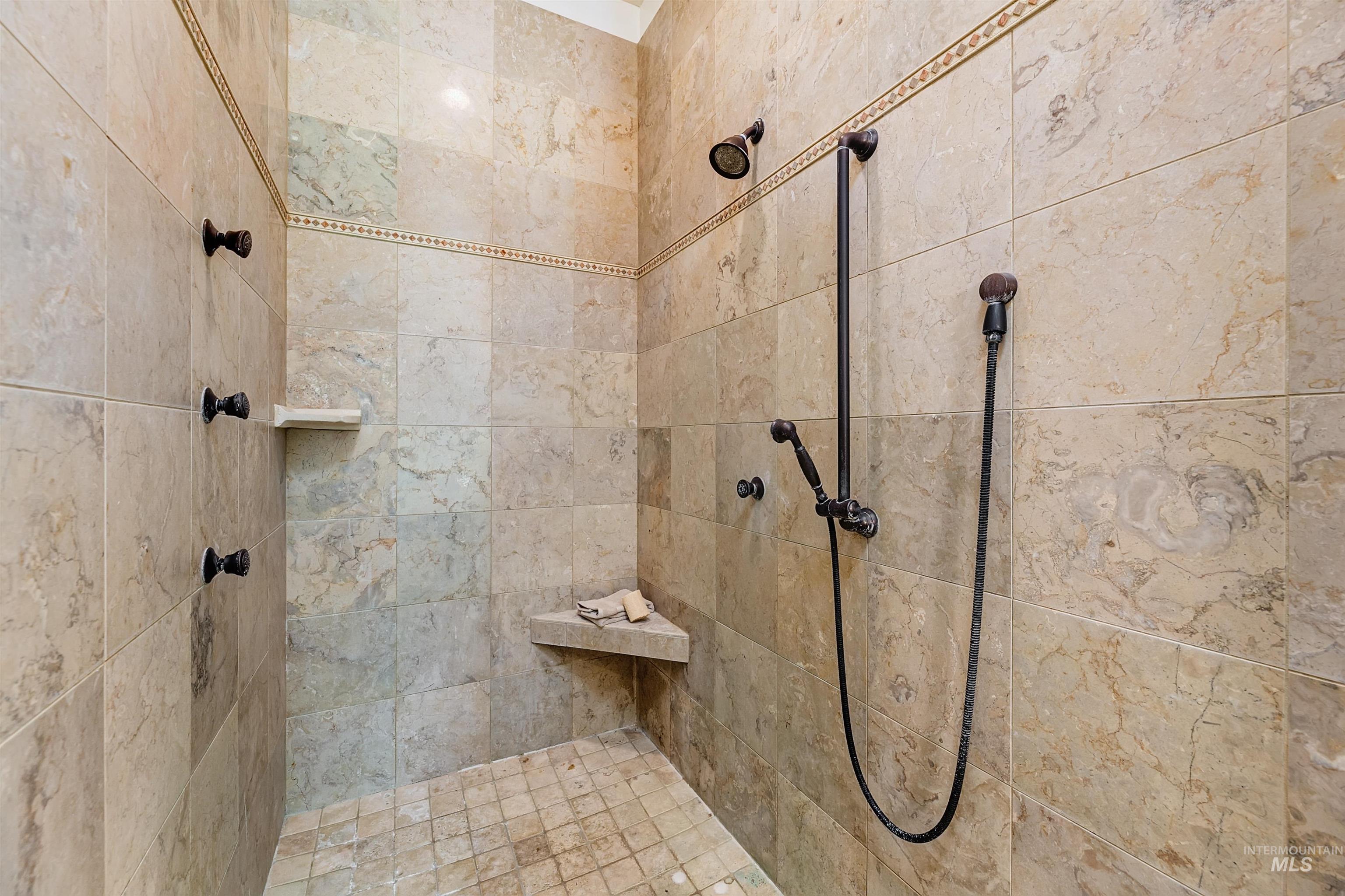 Full bath featuring a tile shower