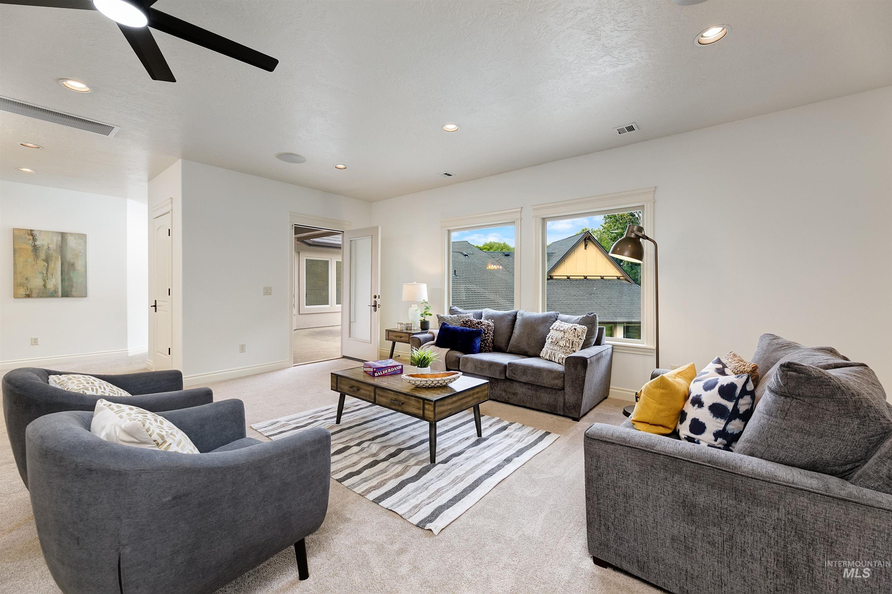Living room featuring recessed lighting, ceiling fan, and carpet flooring