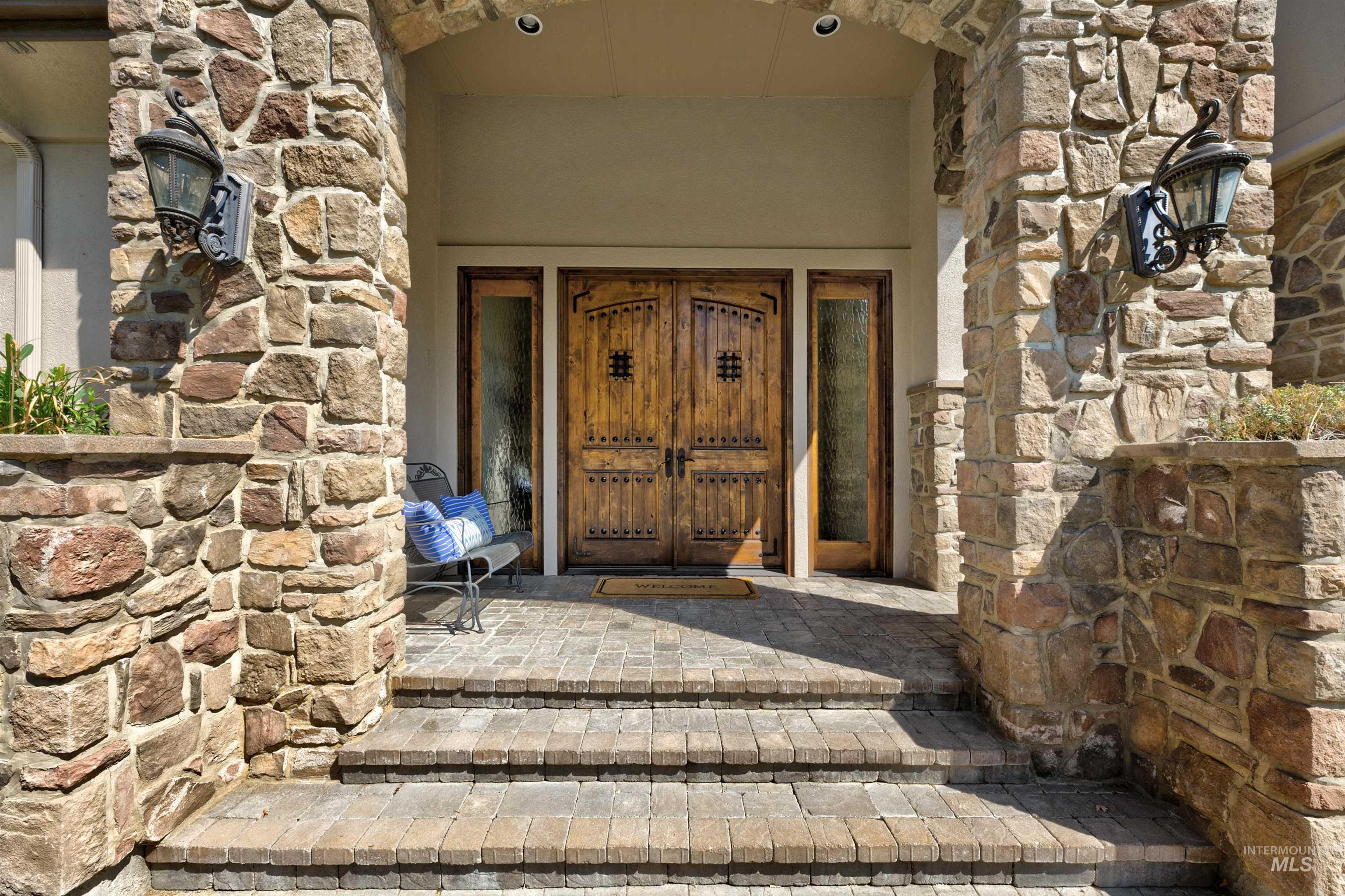 Doorway to property with stone siding and french doors