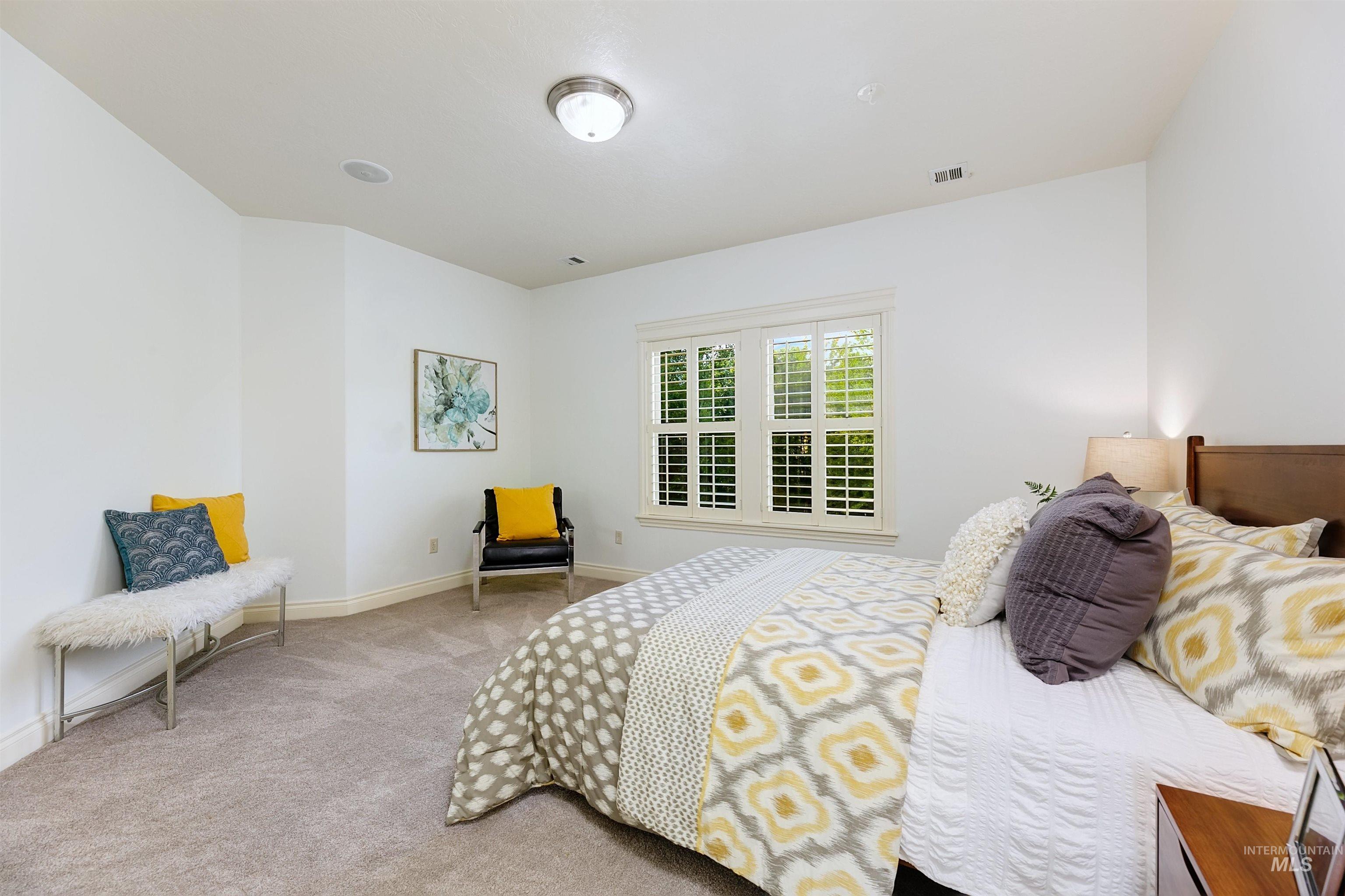 Bedroom featuring carpet and baseboards