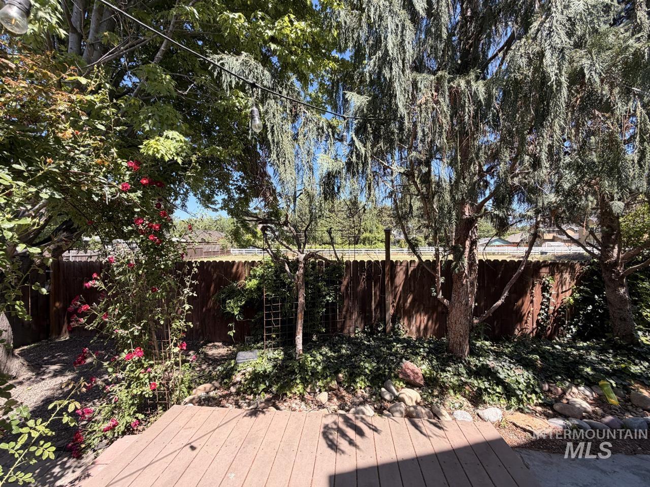 Outdoor decking area with a slatted privacy fence