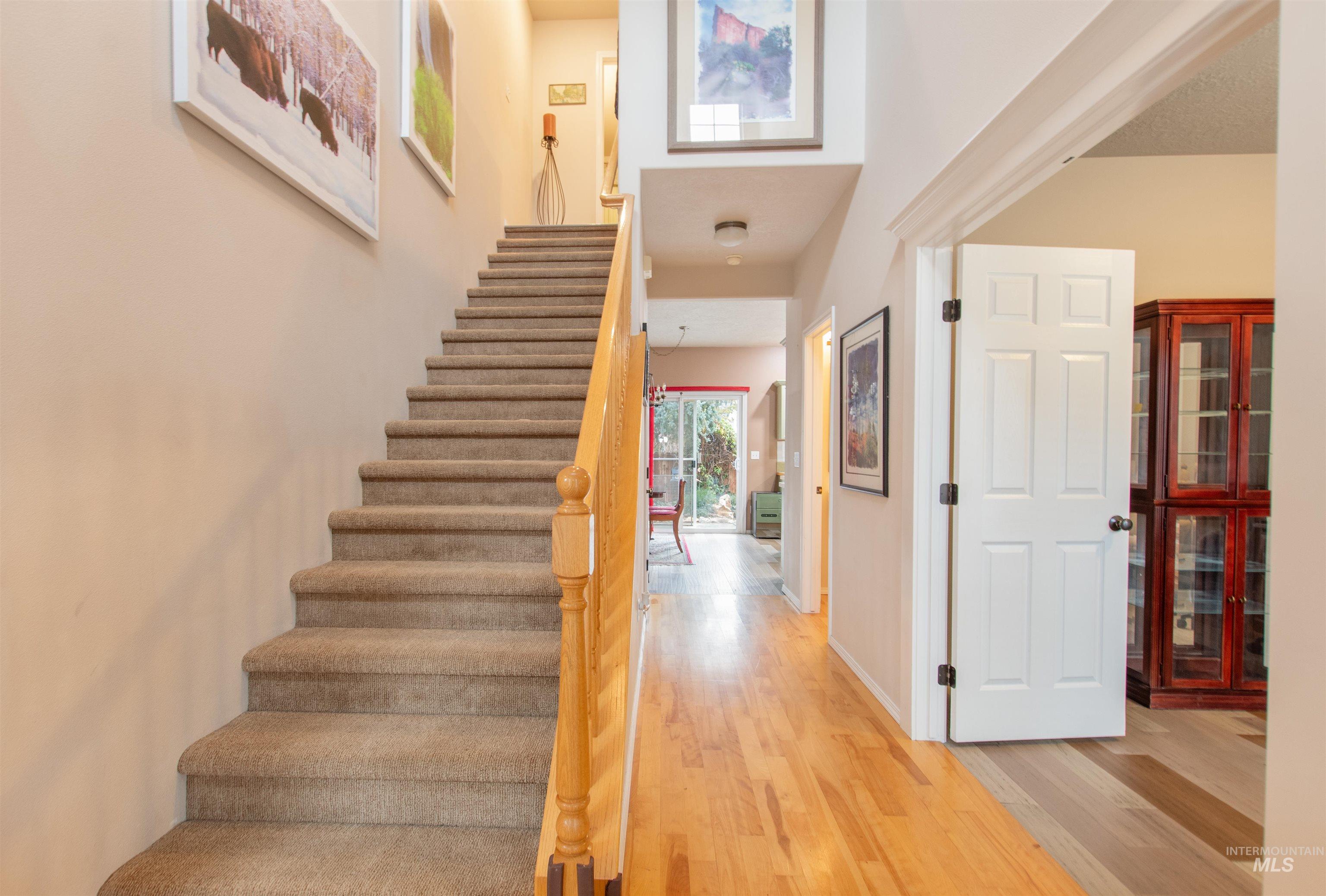 Staircase featuring wood finished floors and baseboards