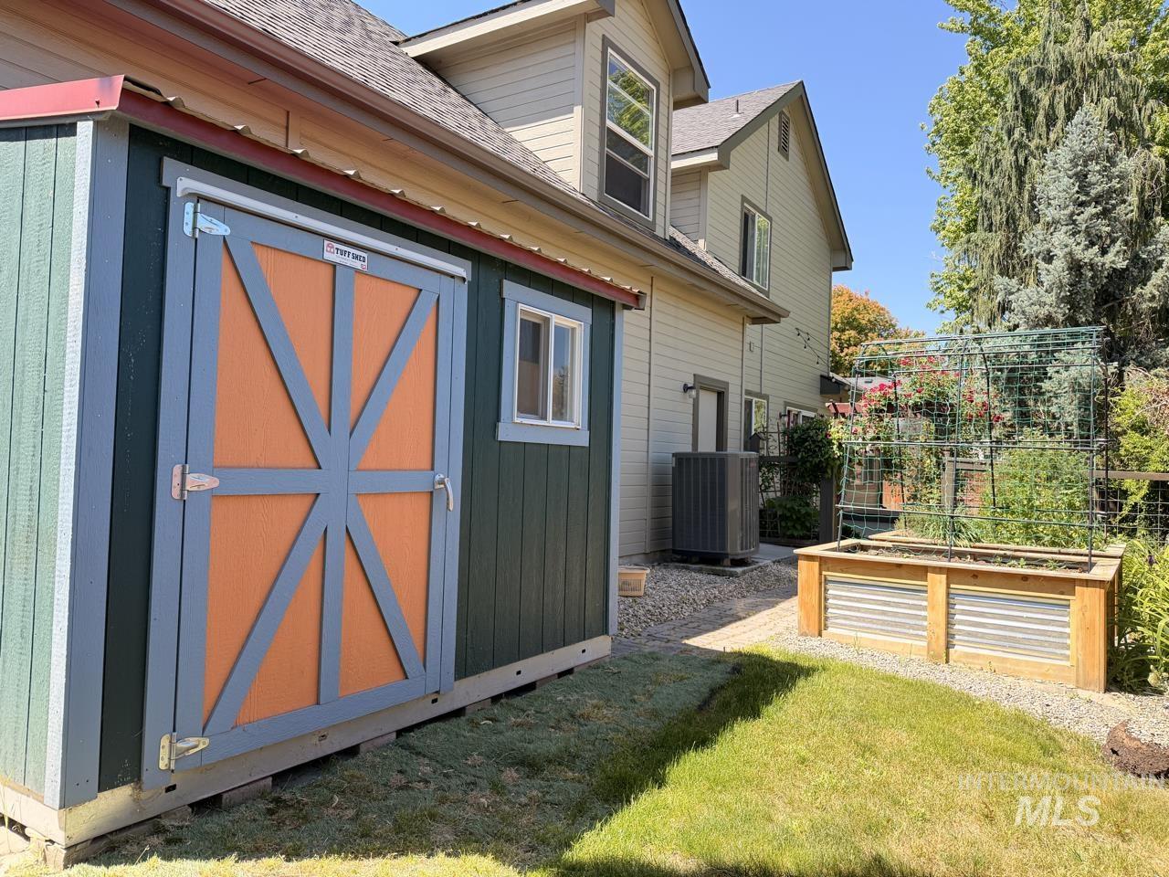 Dedicated storage shed with a panelized door and a transom window