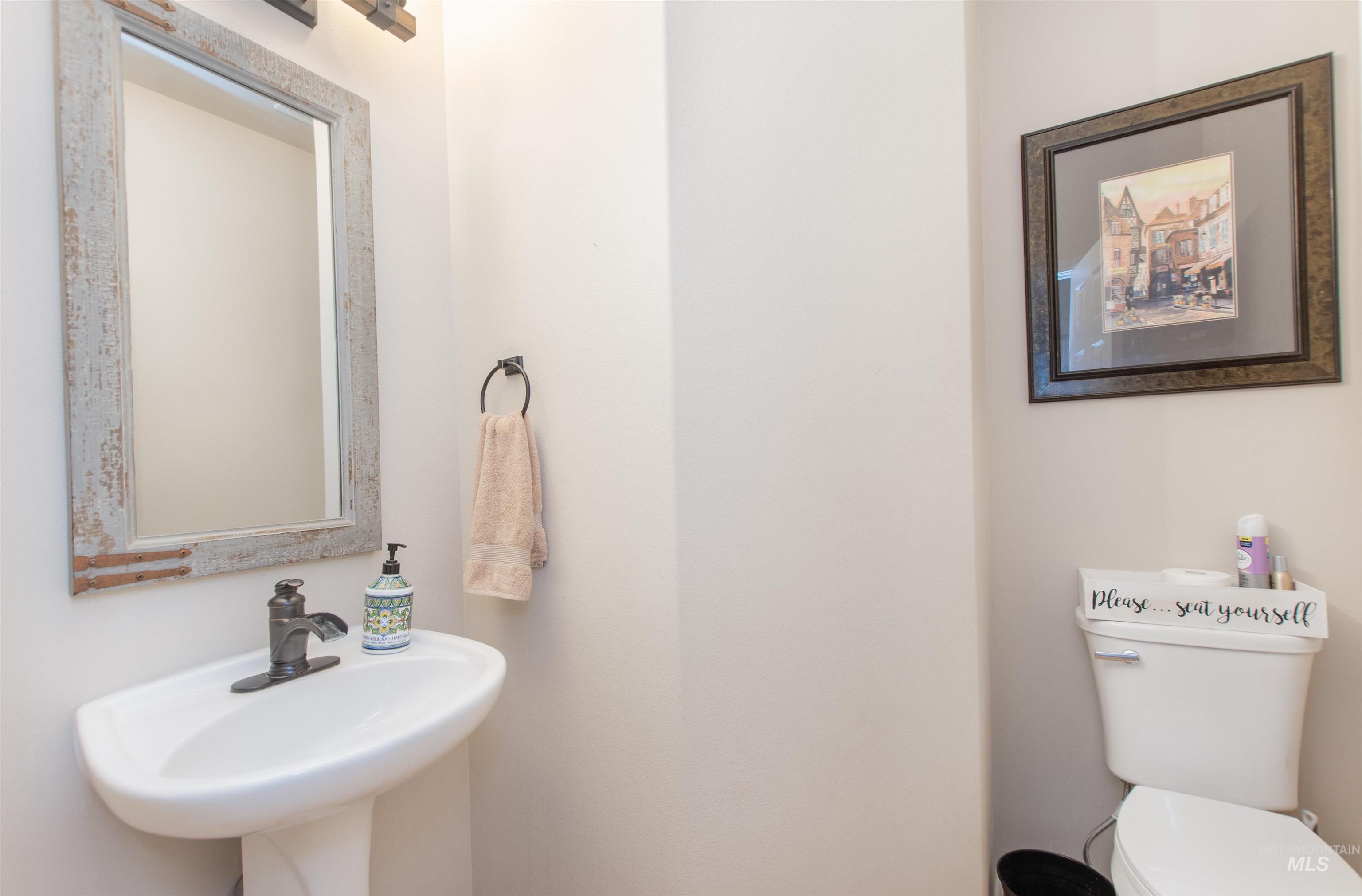 Half bathroom featuring toilet and a sink