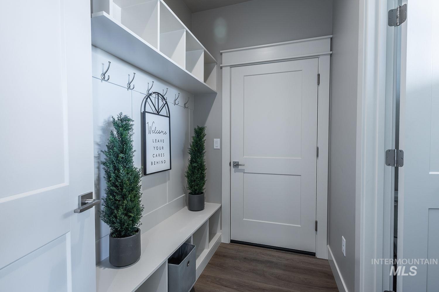 Built-in mudroom storage featuring cubbies, a bench, and coat hooks