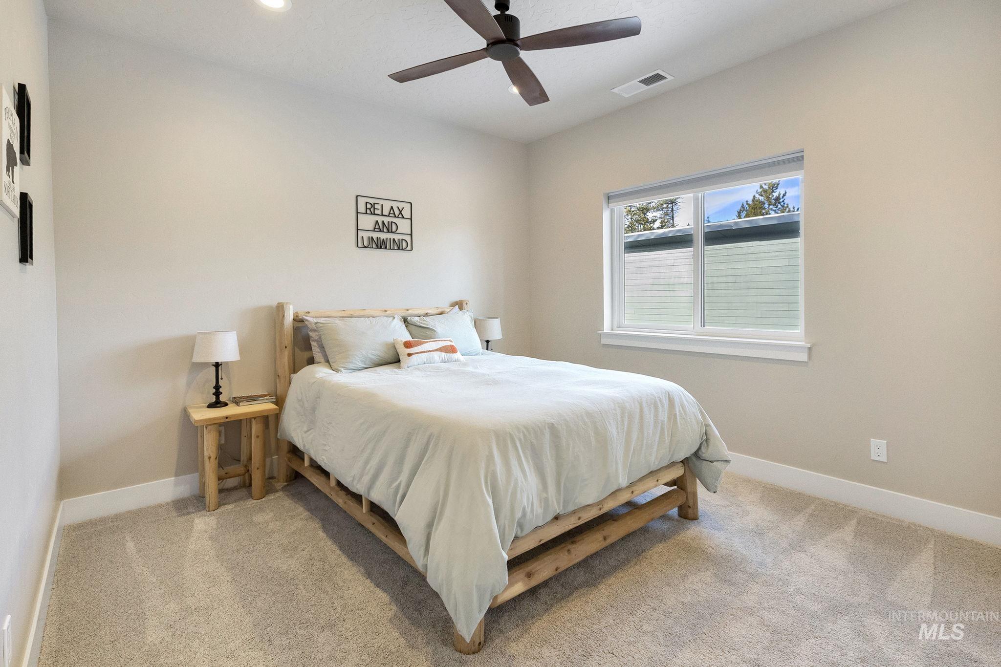 Bedroom featuring light colored carpet, ceiling fan, and recessed lighting