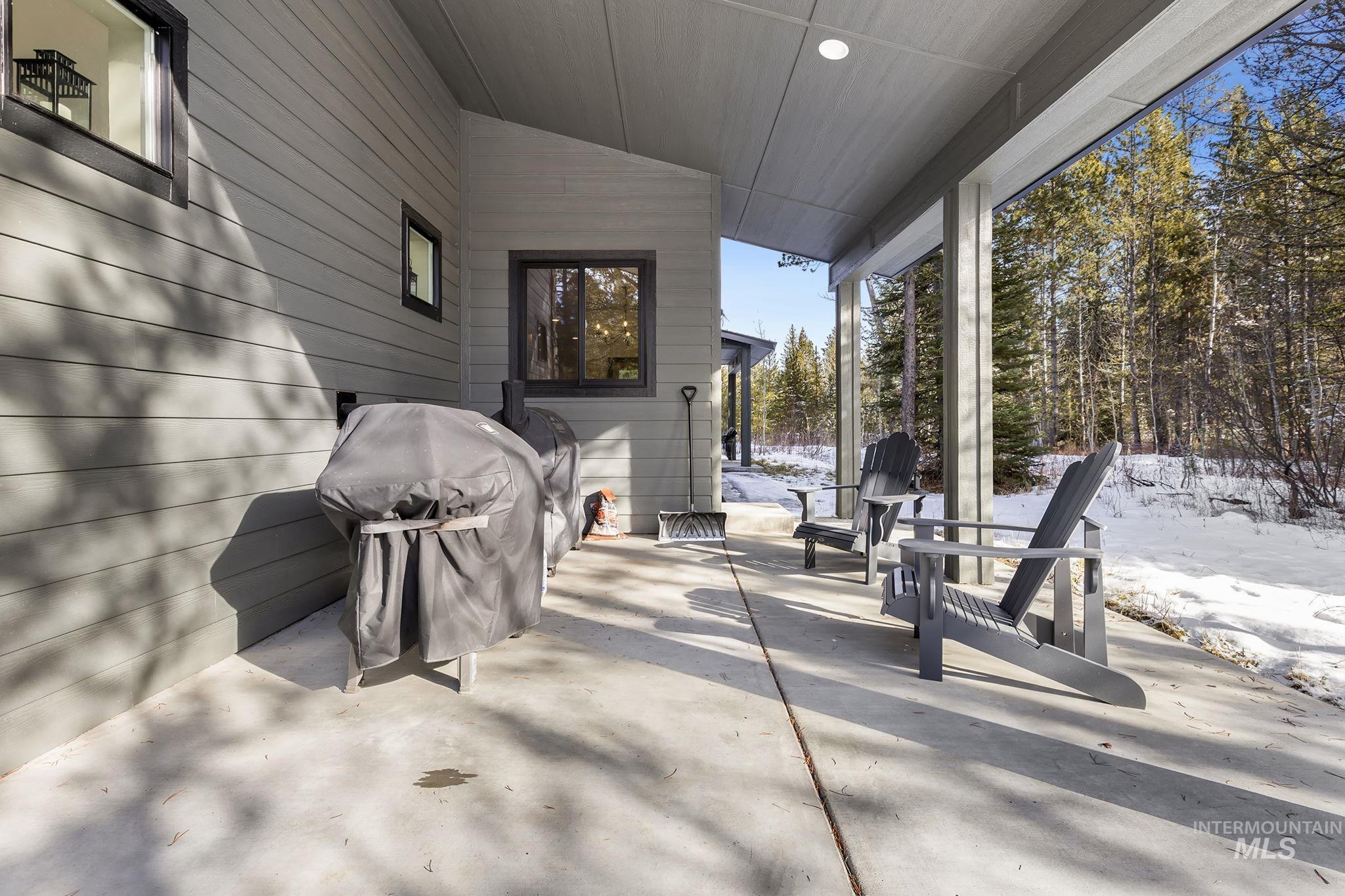 Snow covered patio featuring a patio area and grilling area