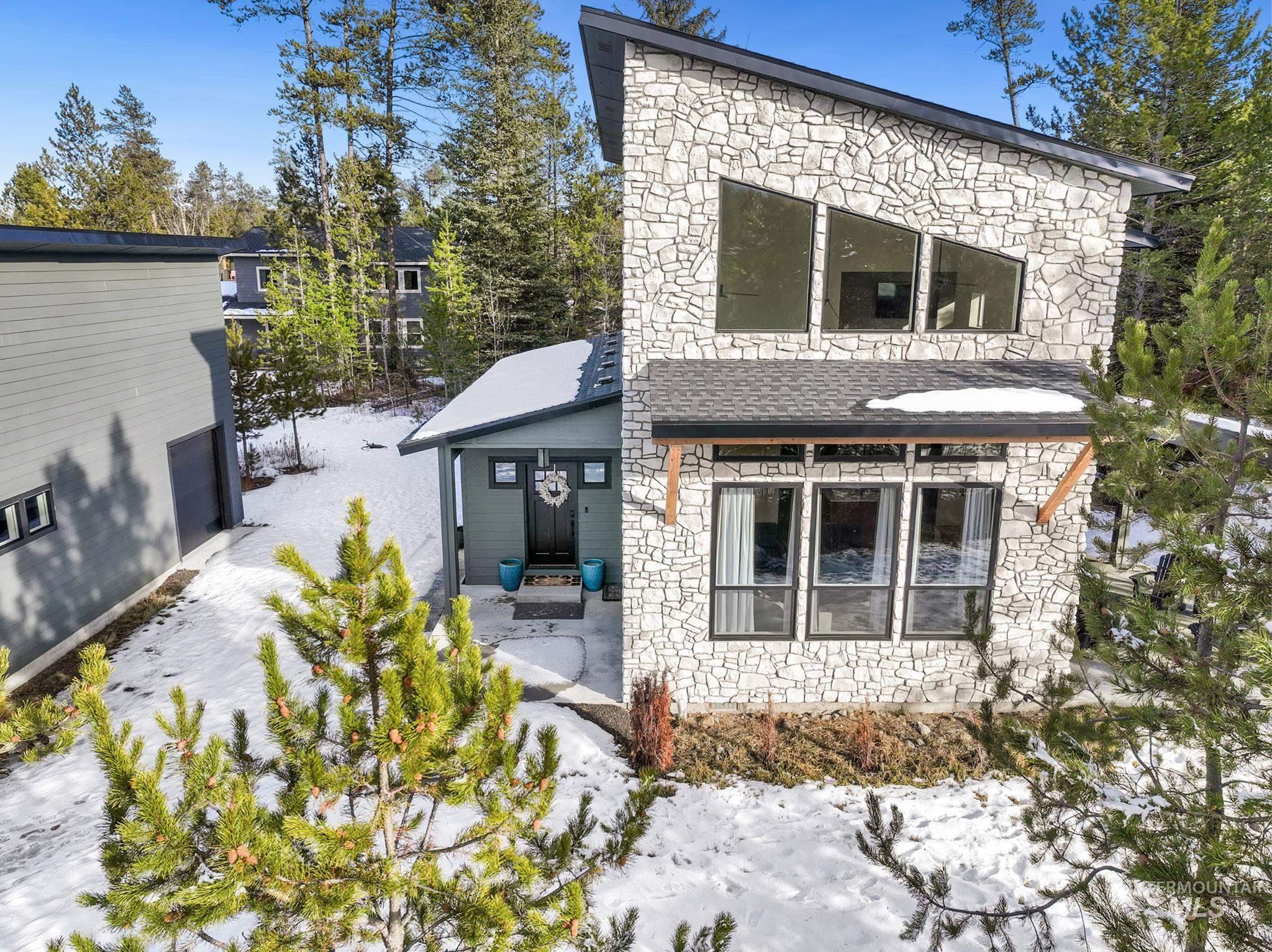 Rear view of house with stone siding