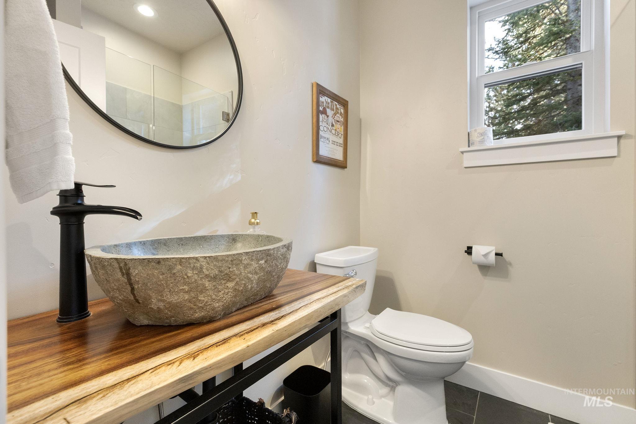 Half bathroom featuring vanity and tile patterned flooring