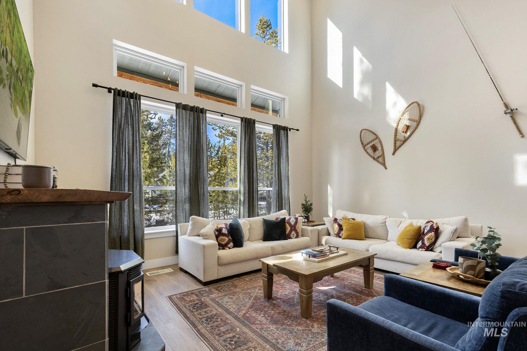 Living area featuring wood finished floors and a high ceiling