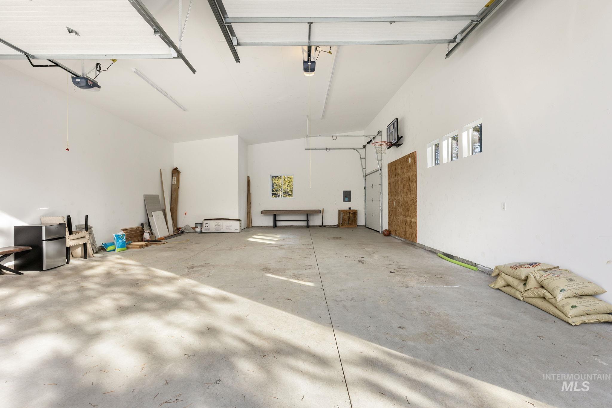 Garage featuring freestanding refrigerator