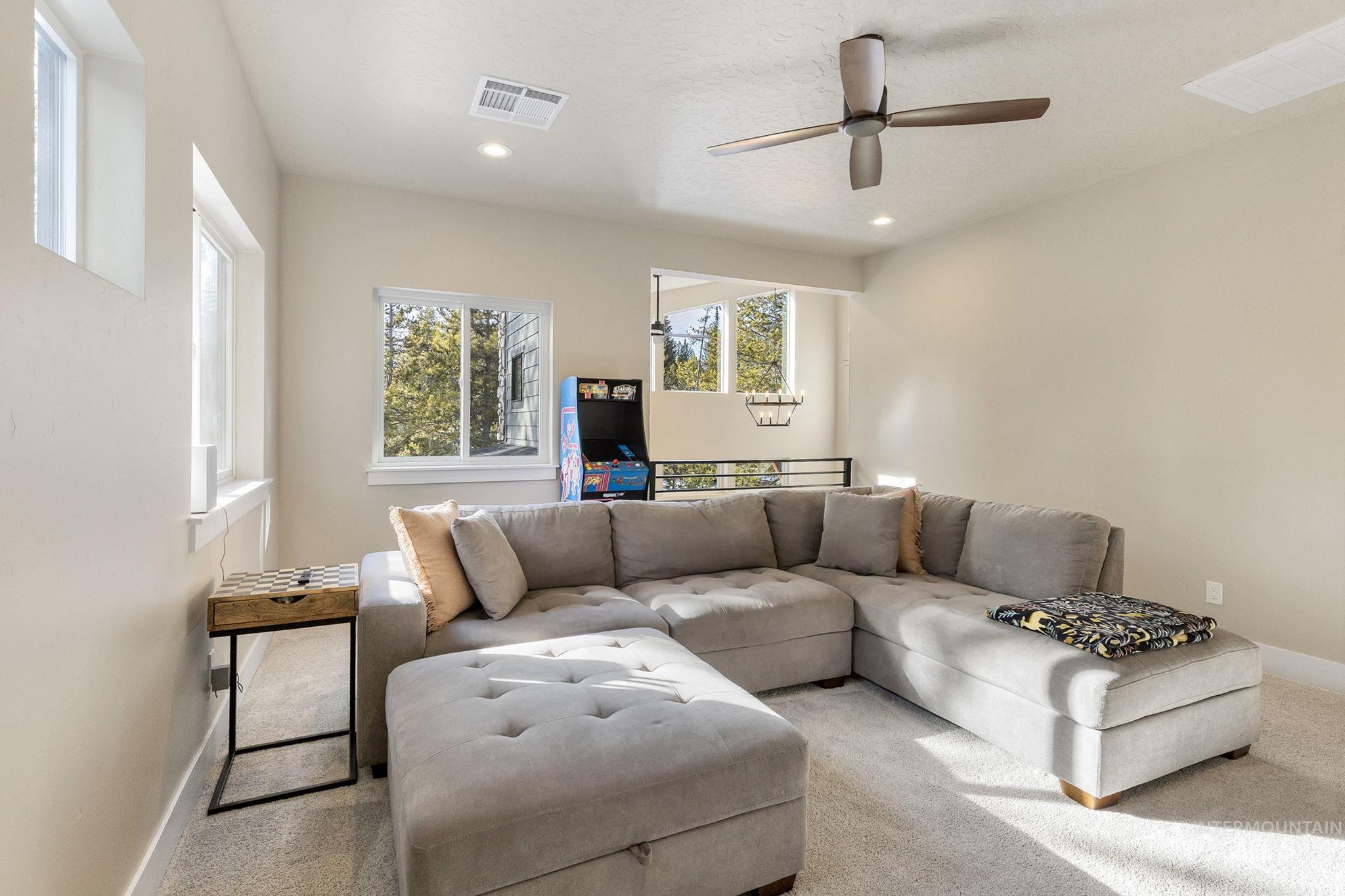 Living area featuring a ceiling fan, carpet floors, and recessed lighting