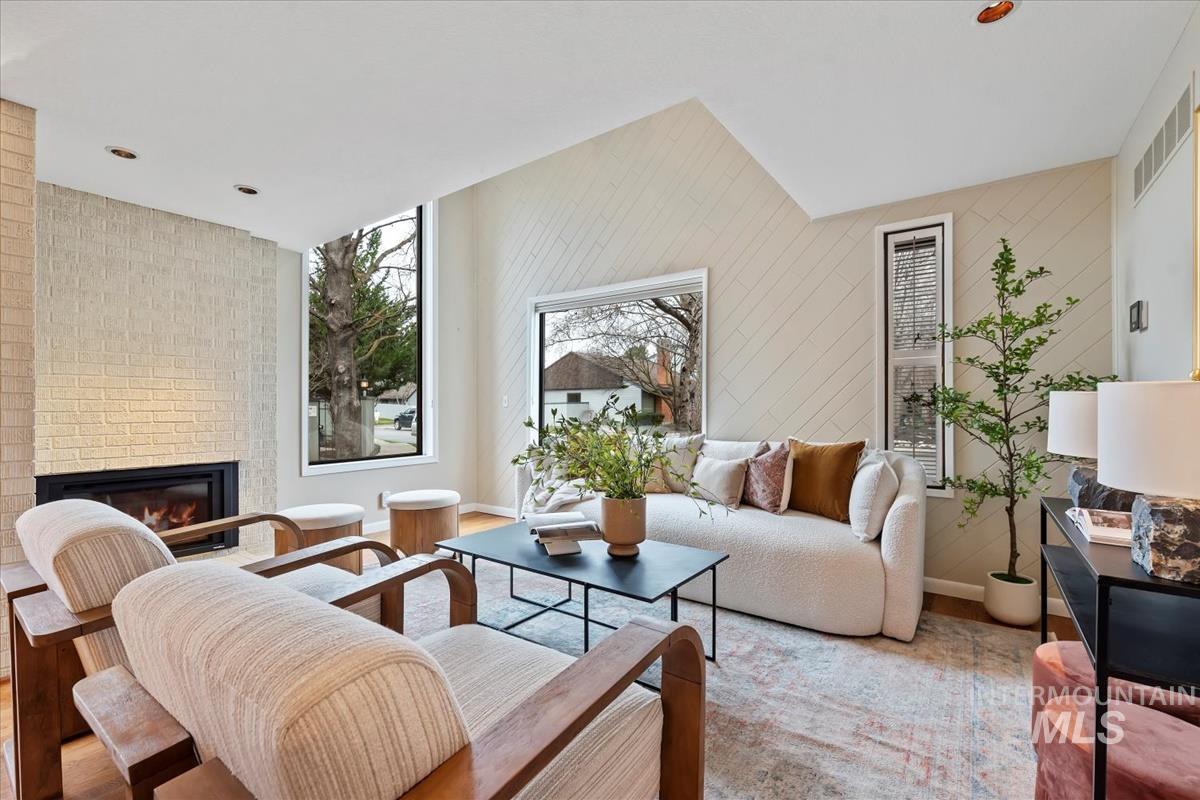 Living room with a fireplace and wooden walls