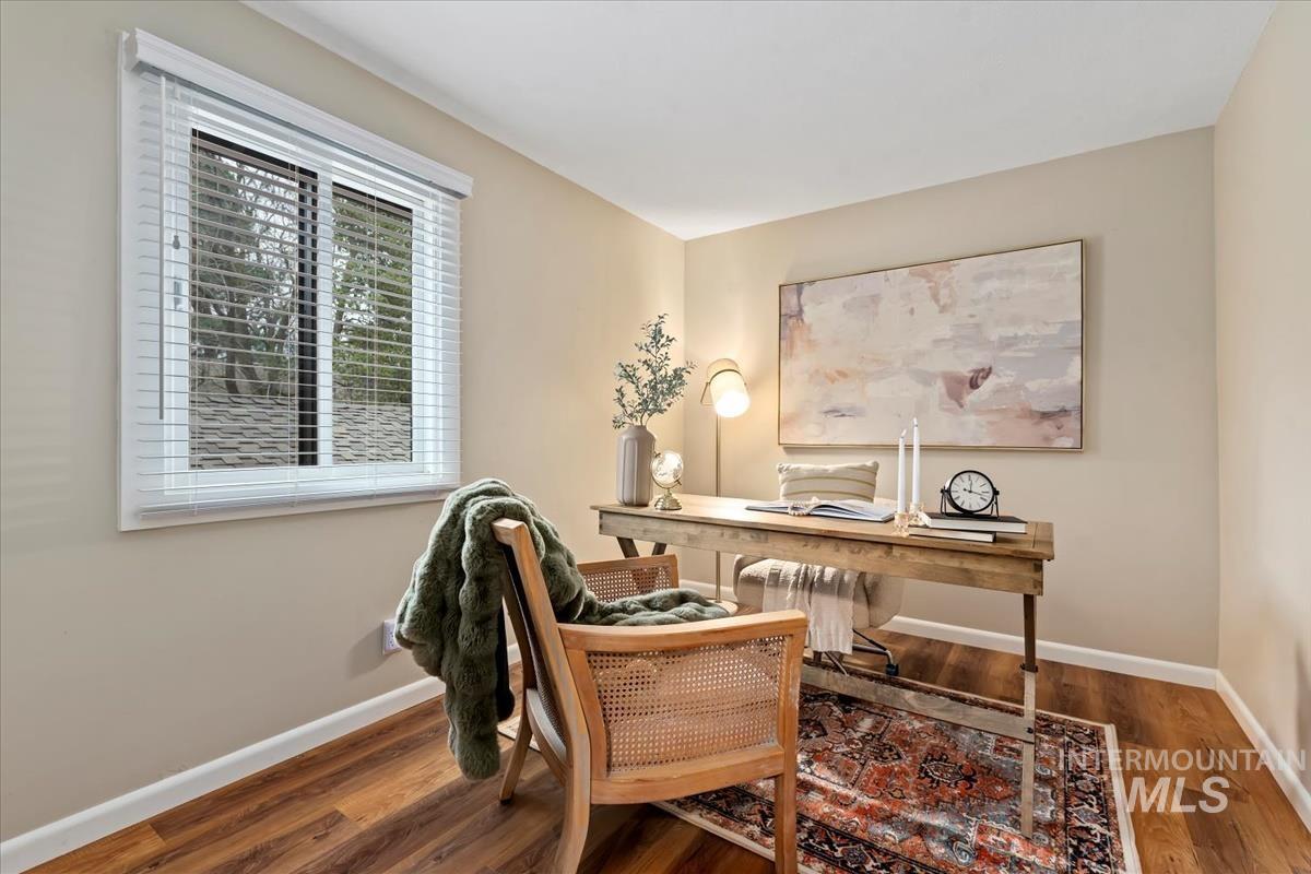 Office space featuring wood finished floors and radiator