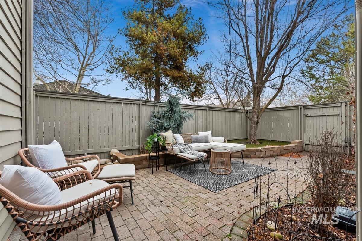 Fenced backyard with a patio area and an outdoor hangout area