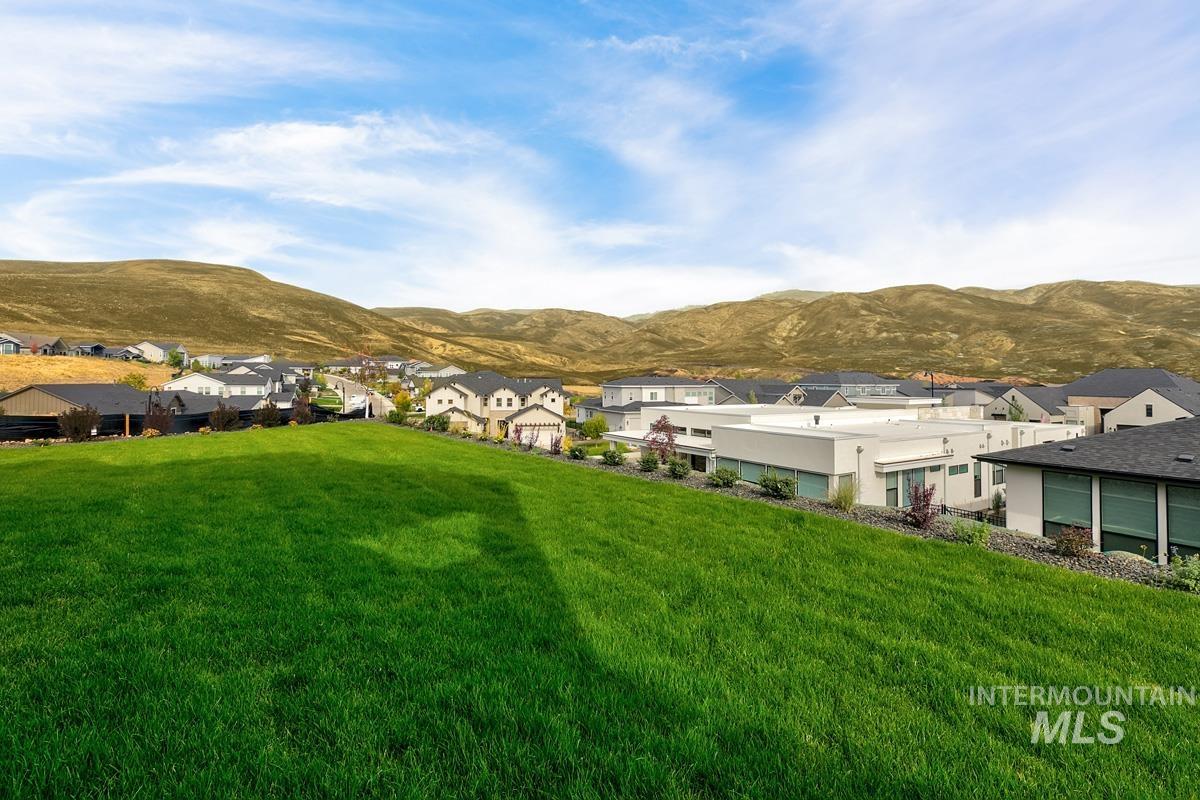 View of green lawn featuring a mountain view and a residential view