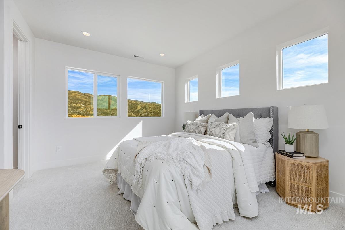 Bedroom featuring light colored carpet and recessed lighting