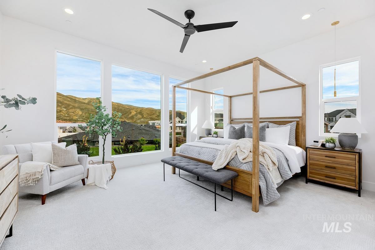 Bedroom featuring multiple windows, light colored carpet, a mountain view, ceiling fan, and recessed lighting