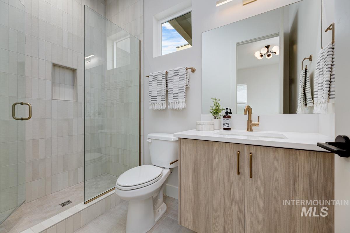 Bathroom featuring vanity, a stall shower, and light tile patterned floors