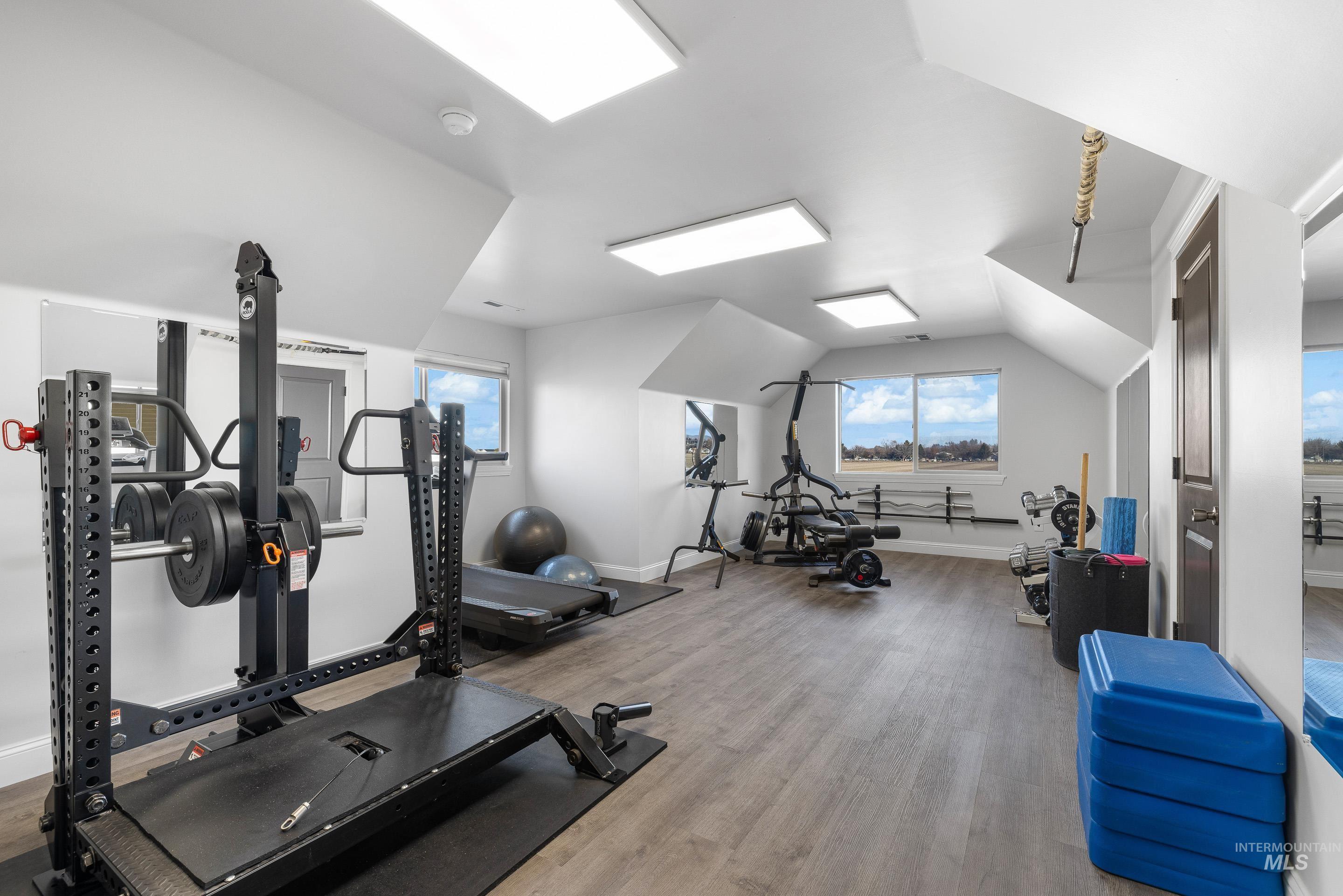 Exercise room featuring vaulted ceiling
