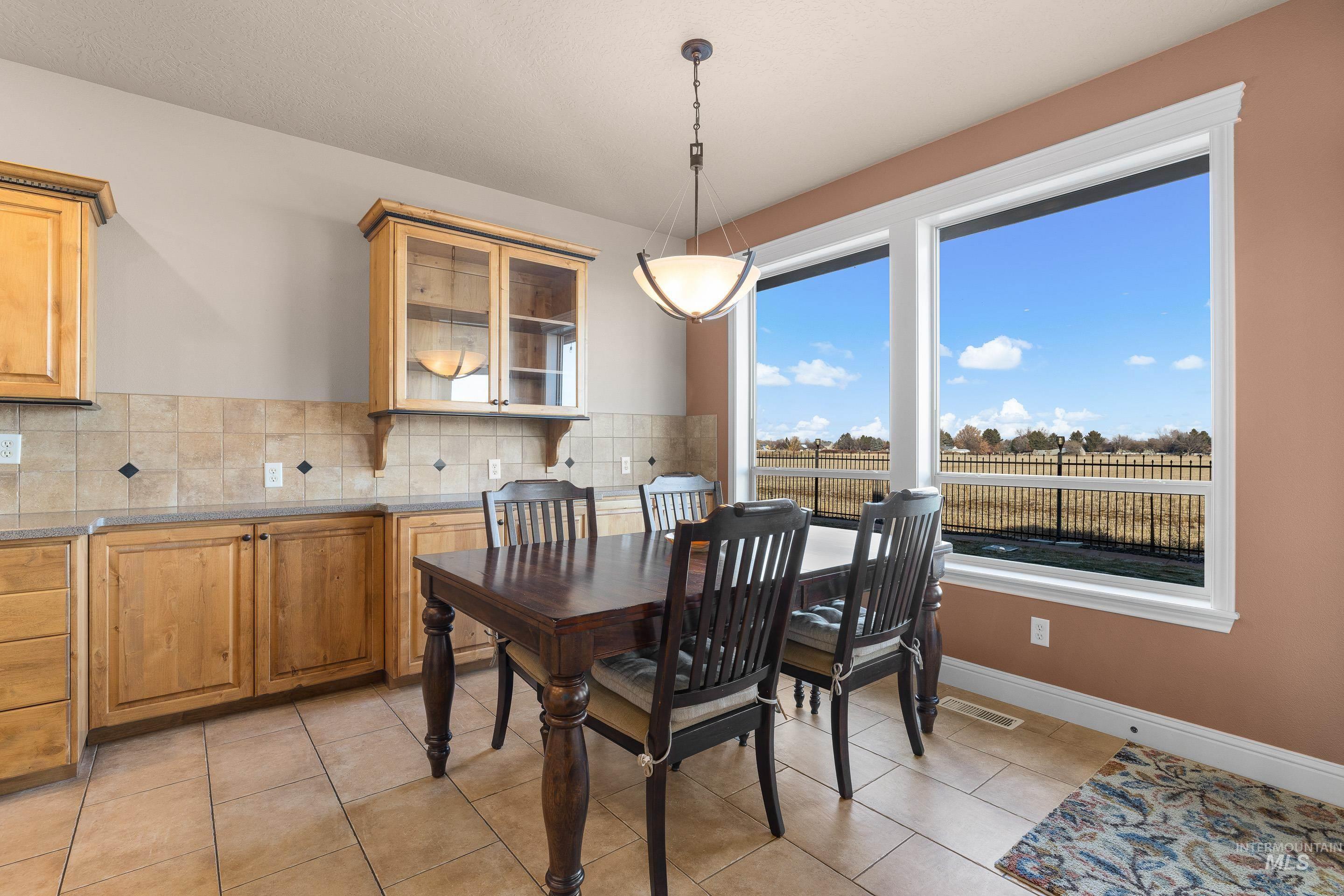 Dining room with light tile patterned floors and a textured ceiling