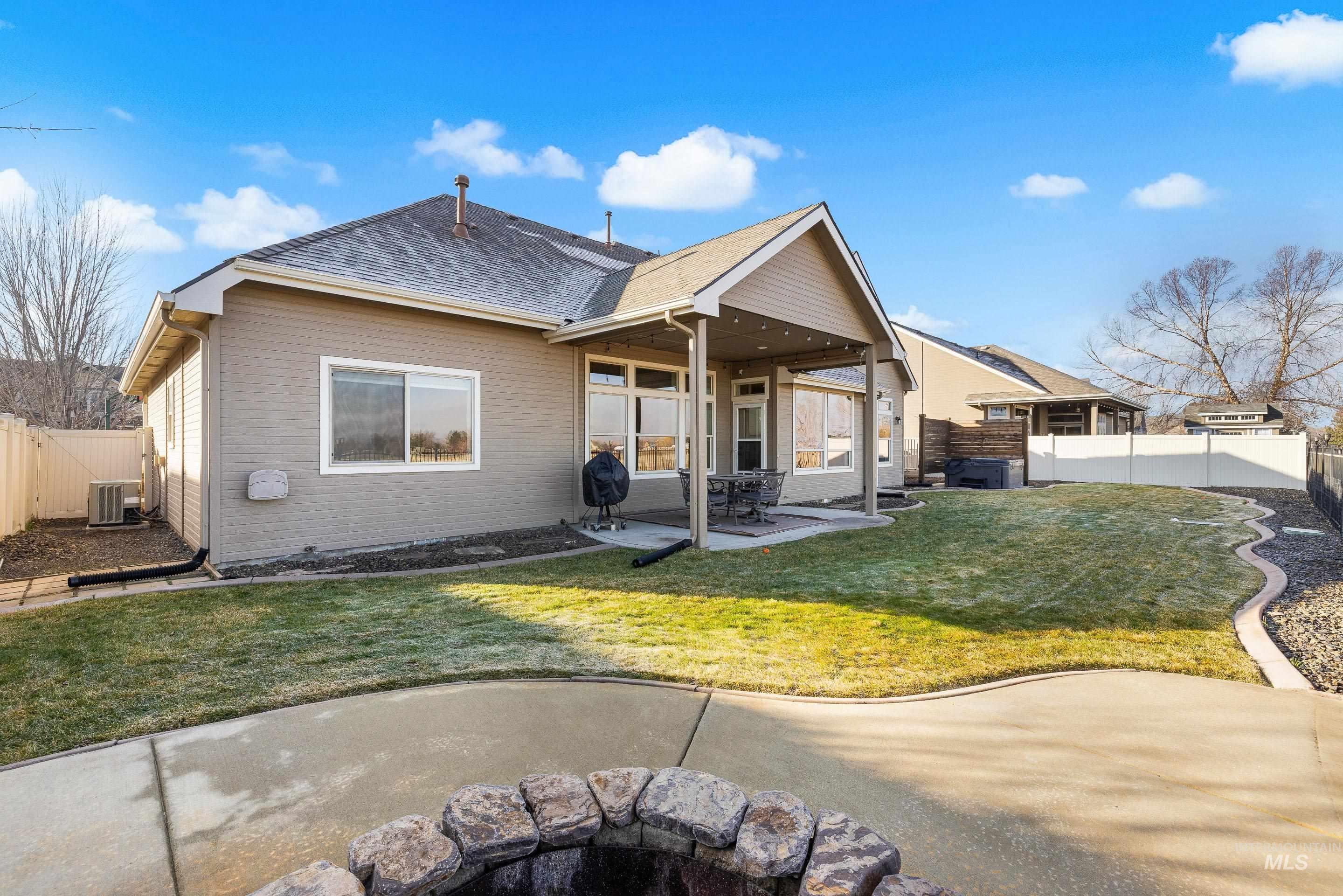 Back of property featuring a fenced backyard, a patio, a gate, and roof with shingles